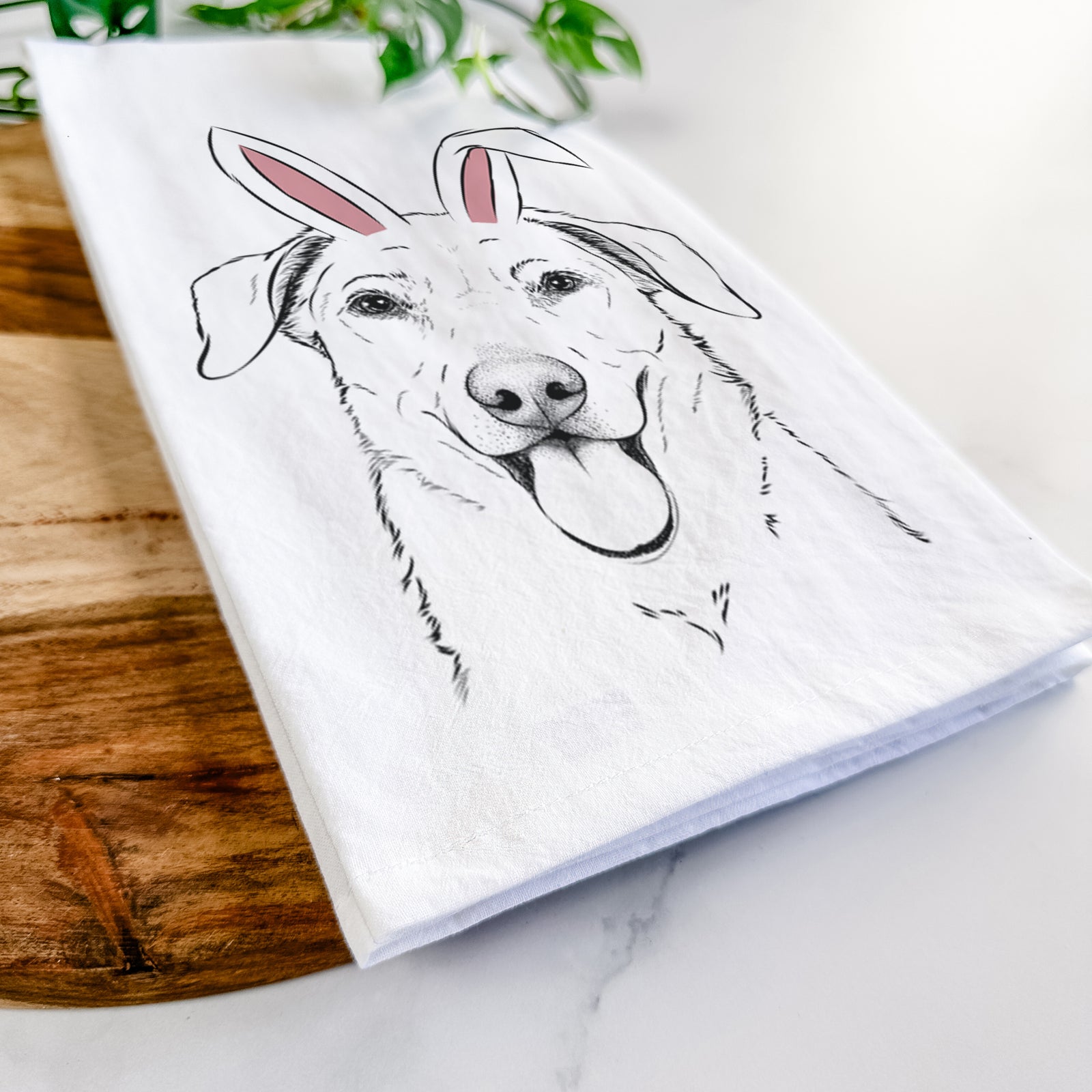 Hand-drawn sketch of Hudson the Shepherd wearing Easter bunny ears on a tea towel