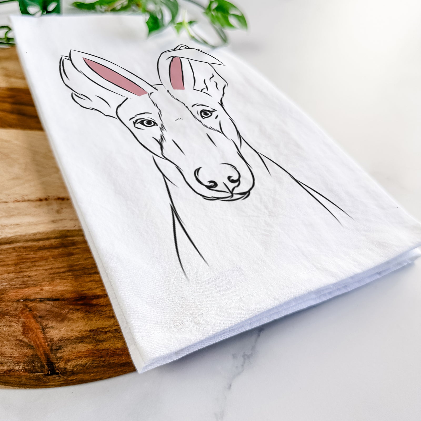 Hand-drawn sketch of Indy the Ibizan Hound wearing Easter bunny ears on a tea towel