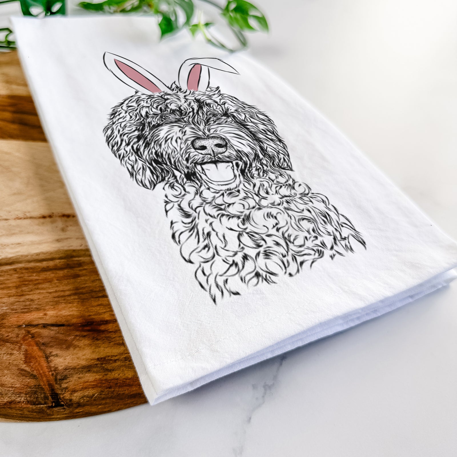 Hand-drawn sketch of Jack the Chocolate Labradoodle wearing Easter bunny ears on a tea towel