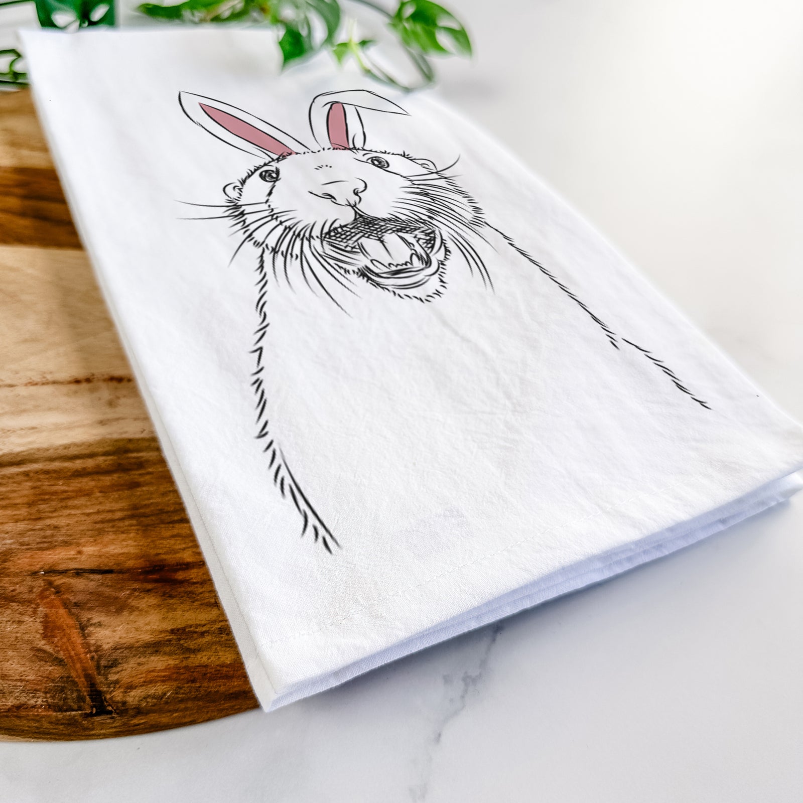 Hand-drawn sketch of Jasper the River Otter wearing Easter bunny ears on a tea towel
