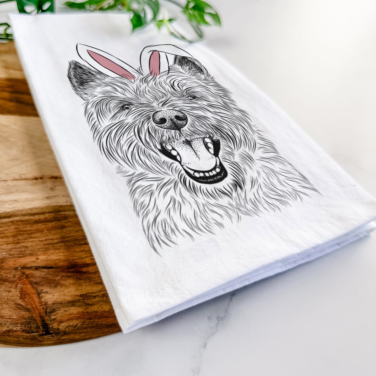 Hand-drawn sketch of Jeff the Cairn Terrier wearing Easter bunny ears on a tea towel