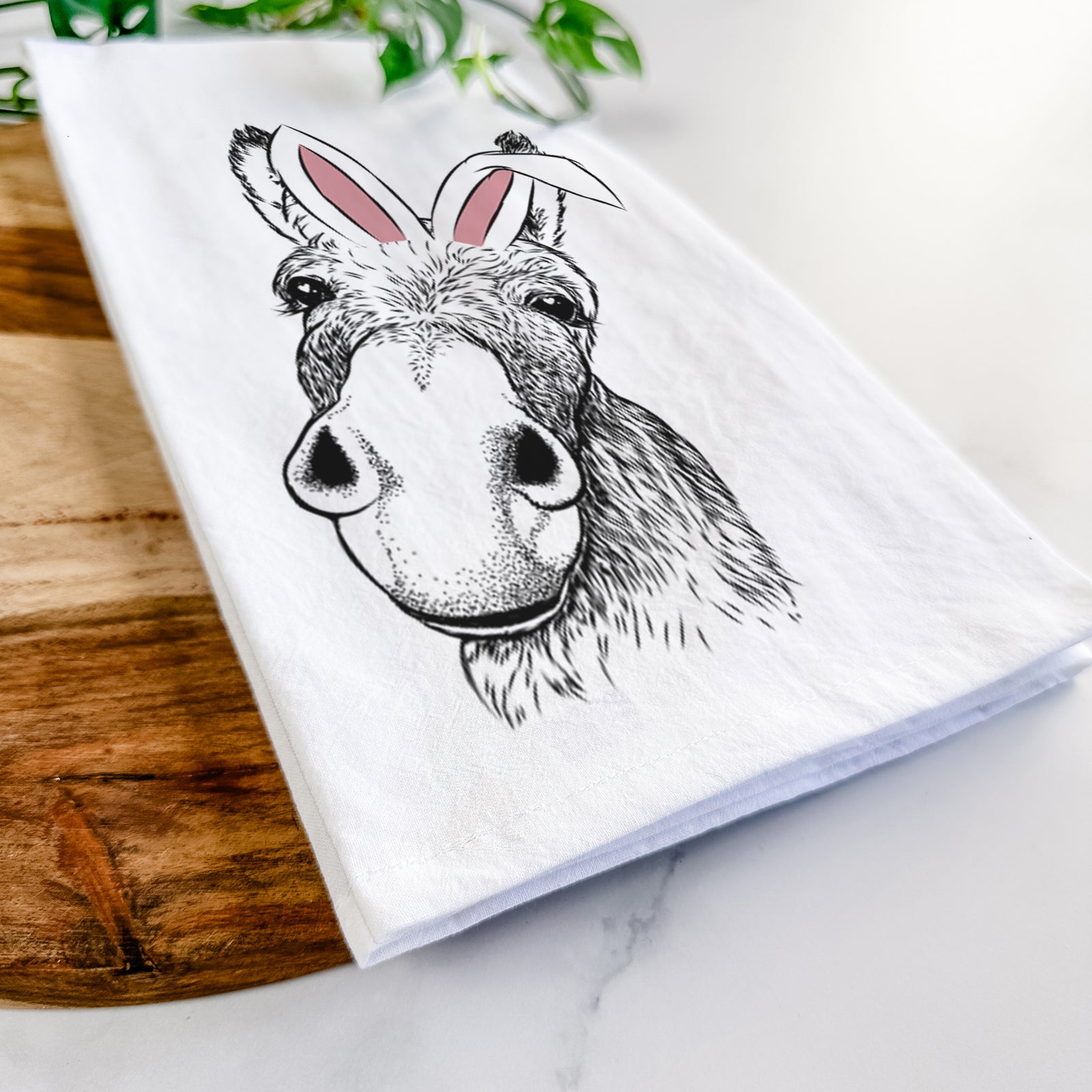 Hand-drawn sketch of Jenny the Donkey wearing Easter bunny ears on a tea towel