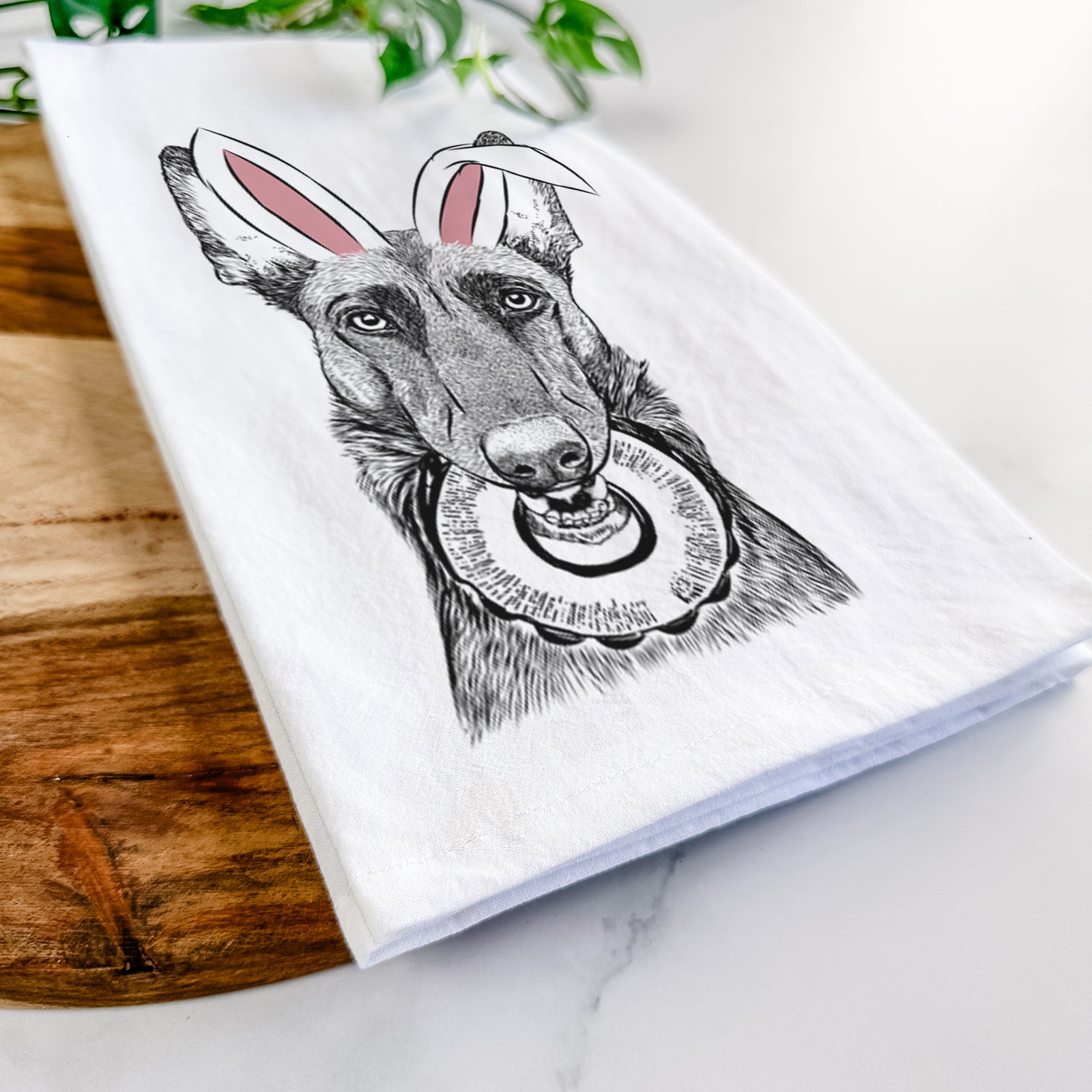 Hand-drawn sketch of Juno the Belgian Malinois wearing Easter bunny ears on a tea towel