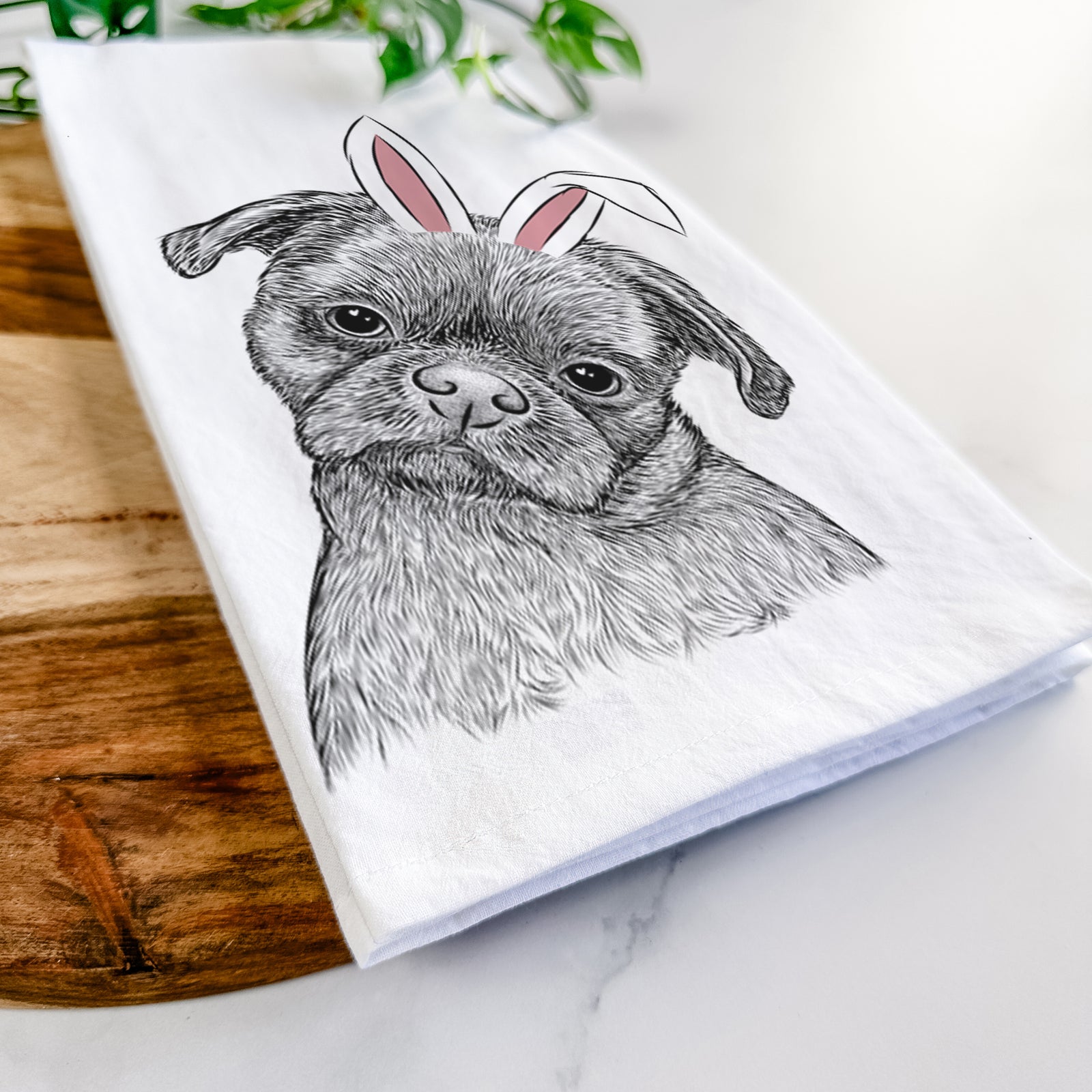 Hand-drawn sketch of Koko the Shih Tzu wearing Easter bunny ears on a tea towel