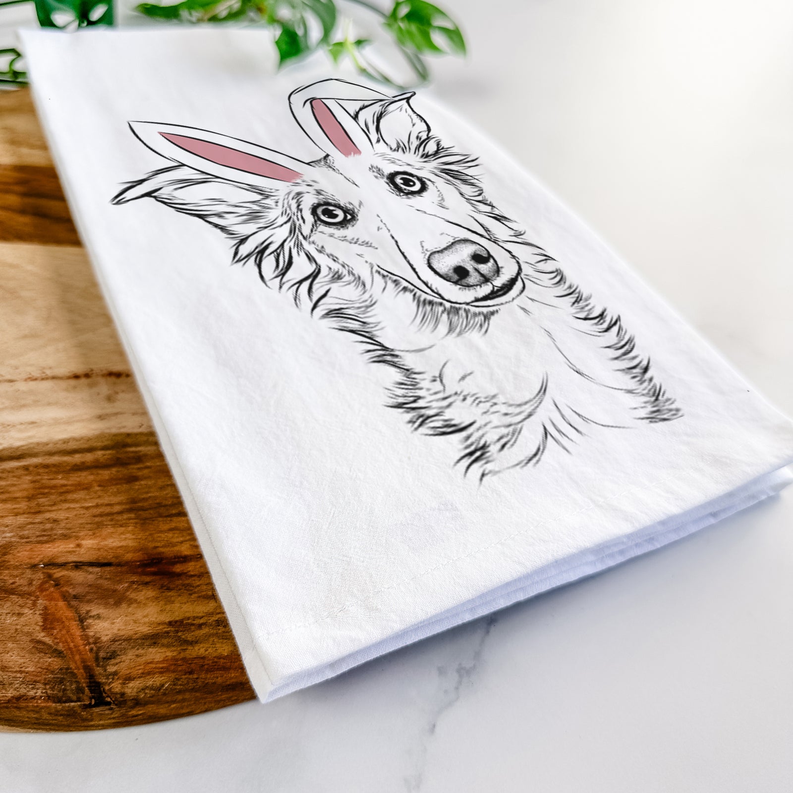 Hand-drawn sketch of Kyu the Windsprite wearing Easter bunny ears on a tea towel