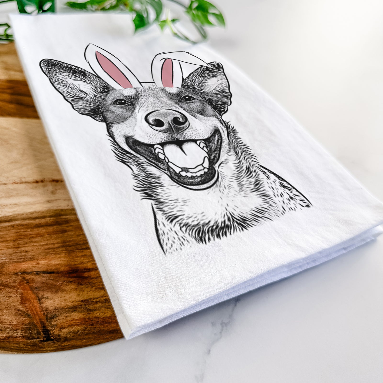 Hand-drawn sketch of Lily the Australian Cattle Dog wearing Easter bunny ears on a tea towel