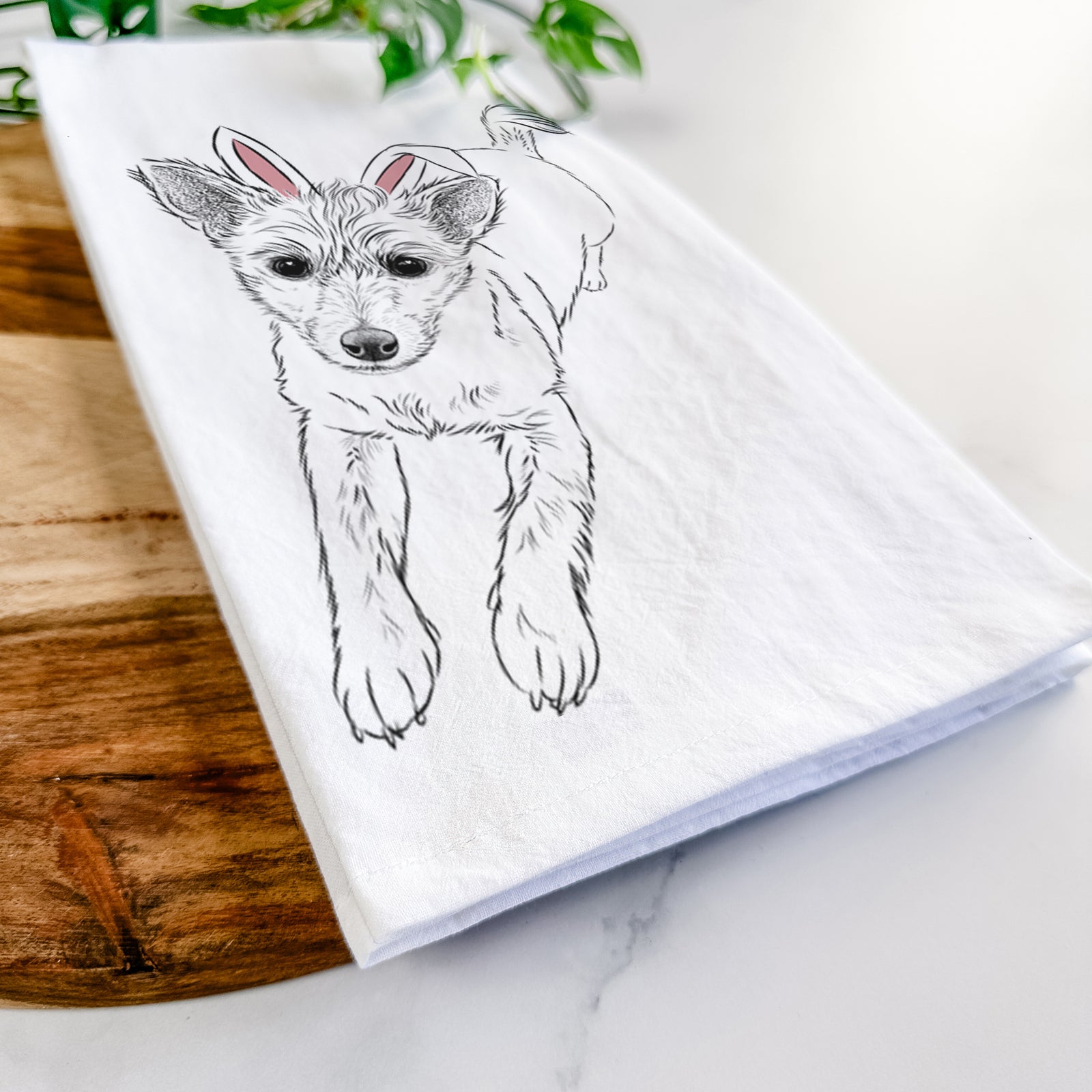 Hand-drawn sketch of Maisie the Terrier Mix wearing Easter bunny ears on a tea towel