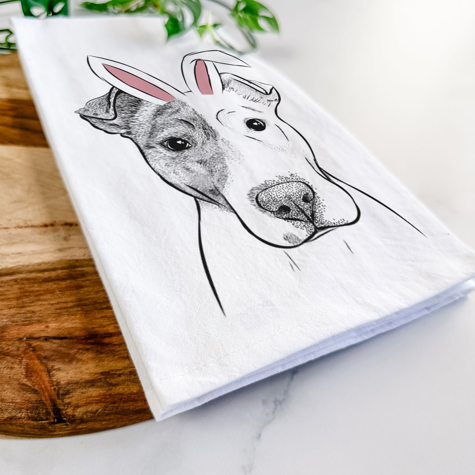 Hand-drawn sketch of Manchi the Pitbull Mix wearing Easter bunny ears on a tea towel
