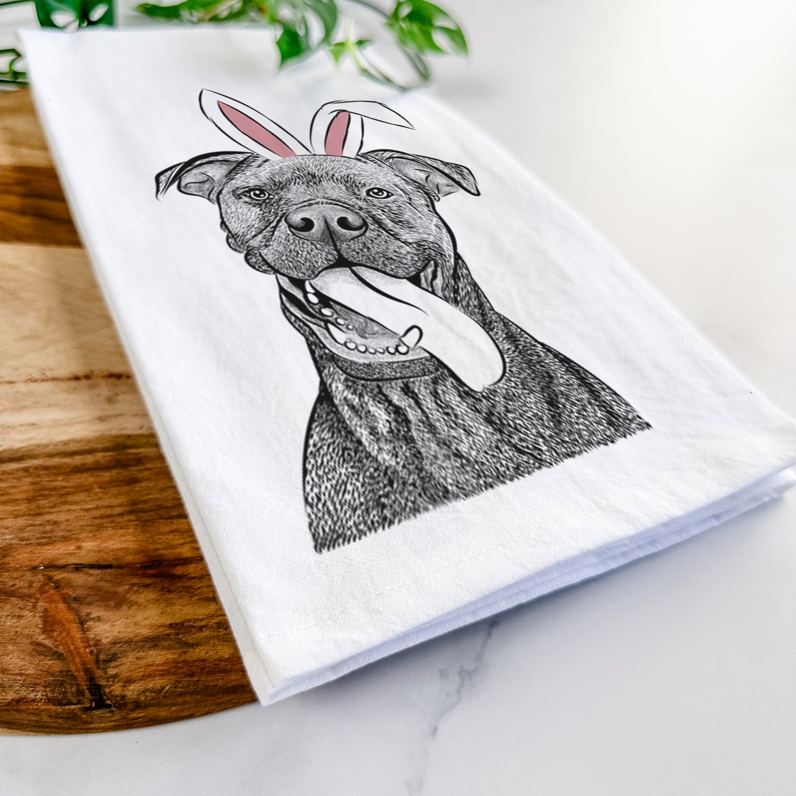 Hand-drawn sketch of Mikey the Boxador wearing Easter bunny ears on a tea towel