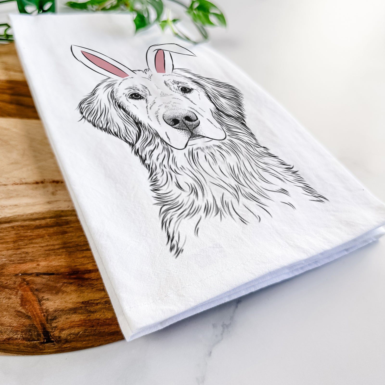 Hand-drawn sketch of Moose the Field Golden Retriever wearing Easter bunny ears on a tea towel
