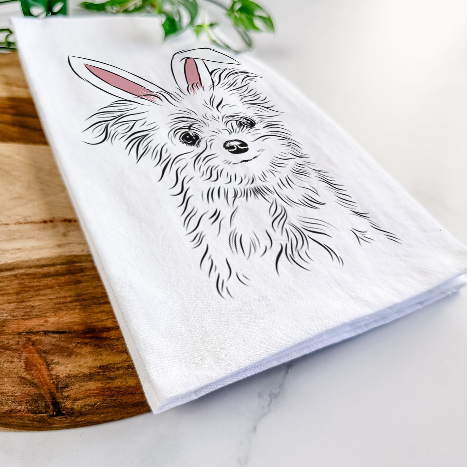Hand-drawn sketch of Mr. Gucci Poochi the Maltese wearing Easter bunny ears on a tea towel