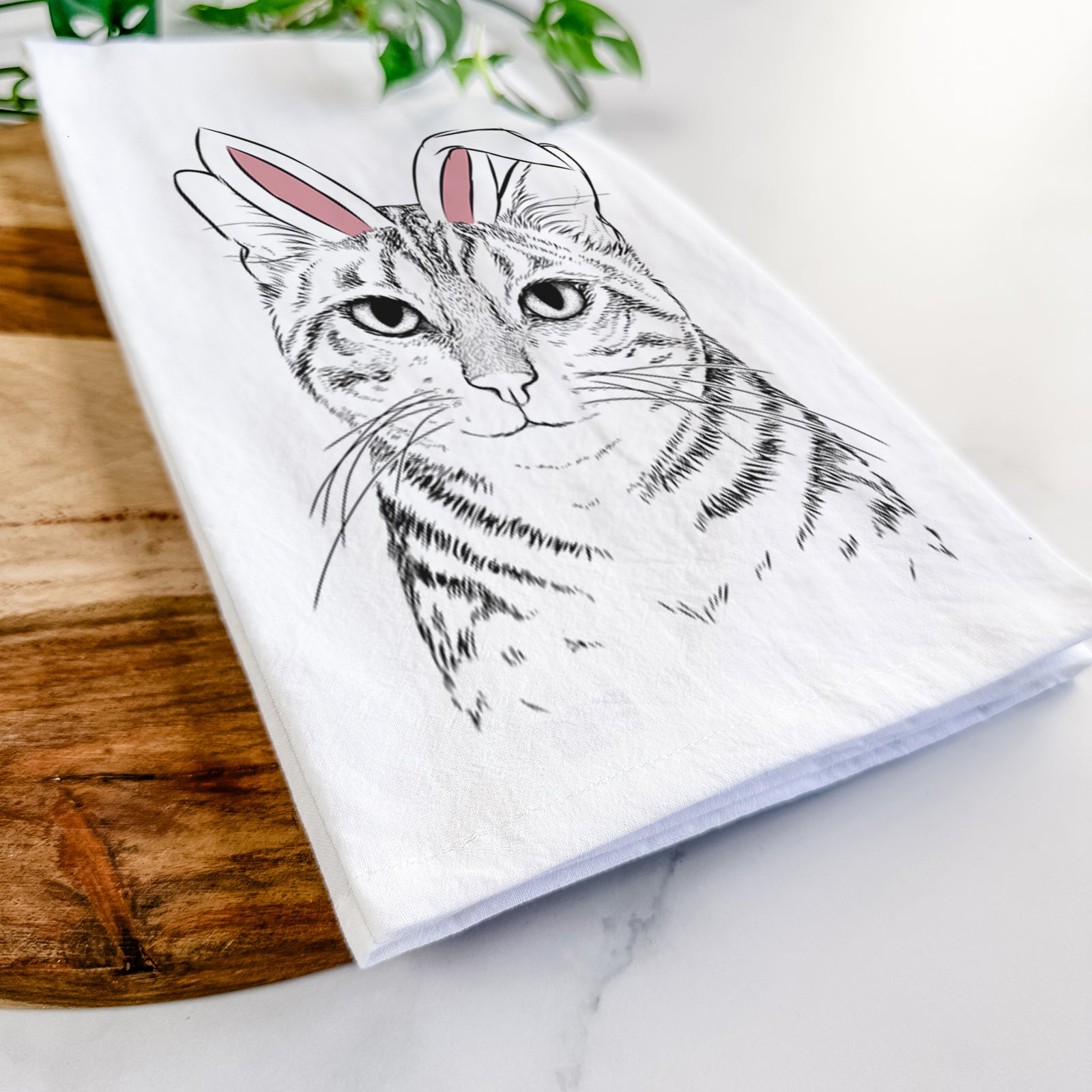 Hand-drawn sketch of Nell the Tabby Cat wearing Easter bunny ears on a tea towel