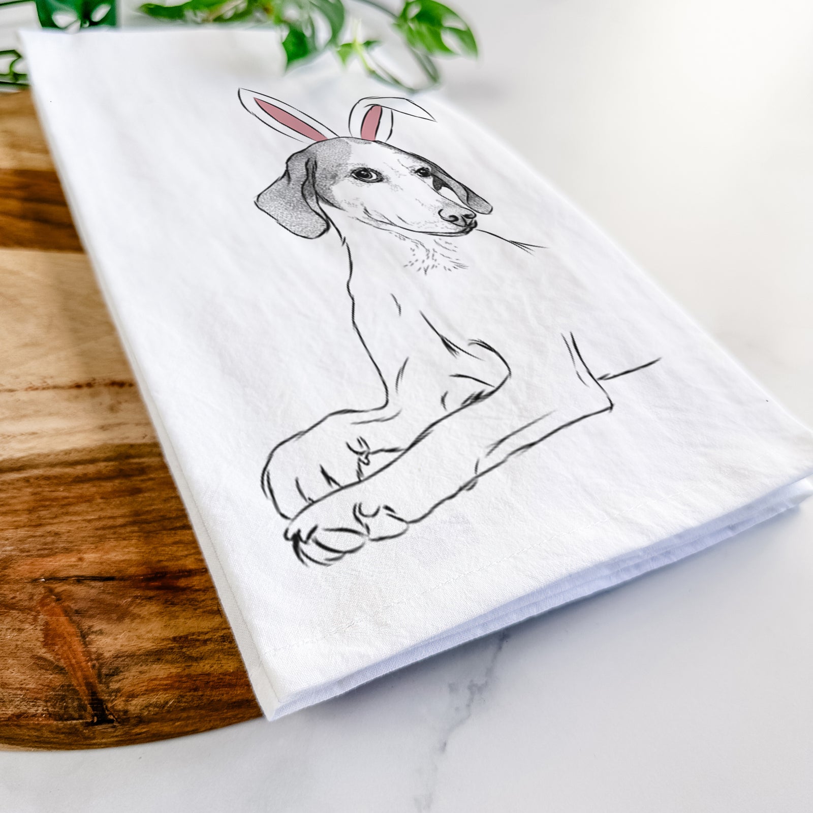 Hand-drawn sketch of Opie the Foxhound wearing Easter bunny ears on a tea towel