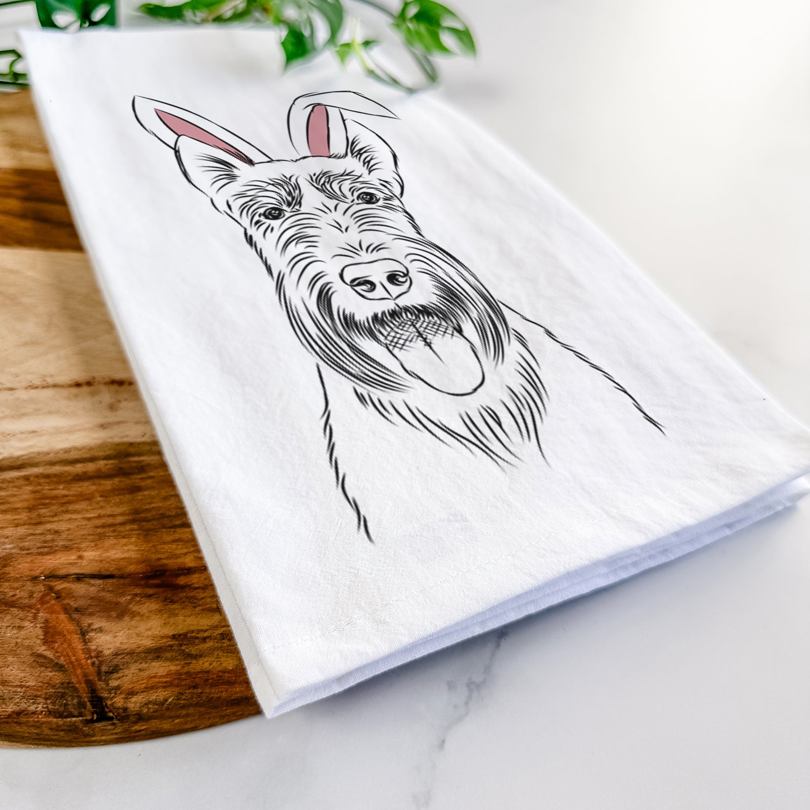 Hand-drawn sketch of Oswald the Scottish Terrier wearing Easter bunny ears on a tea towel