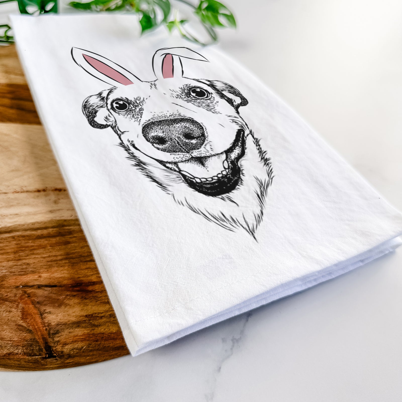 Hand-drawn sketch of Petrah the Staffy Mix wearing Easter bunny ears on a tea towel