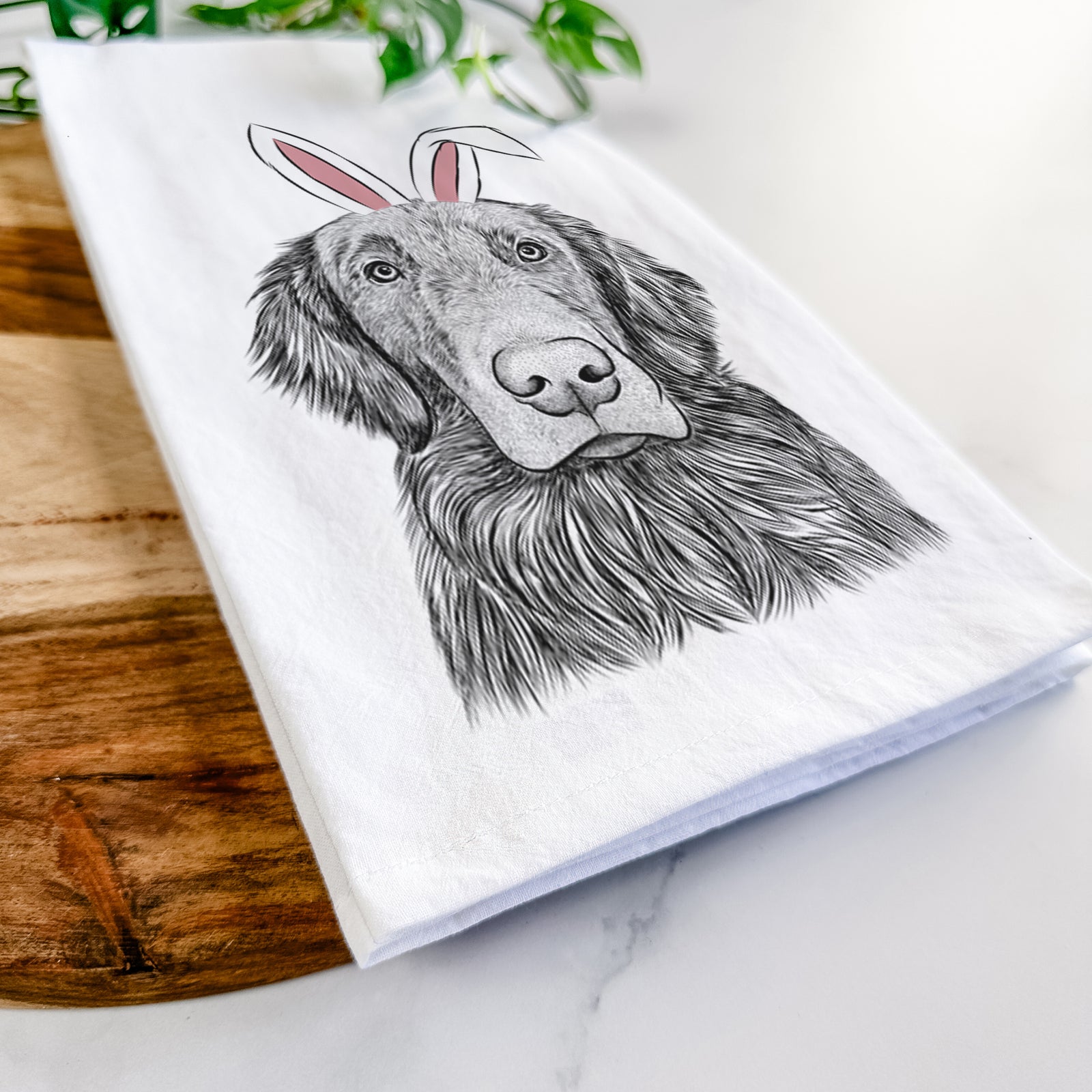 Hand-drawn sketch of Pippin the Flat Coated Retriever wearing Easter bunny ears on a tea towel