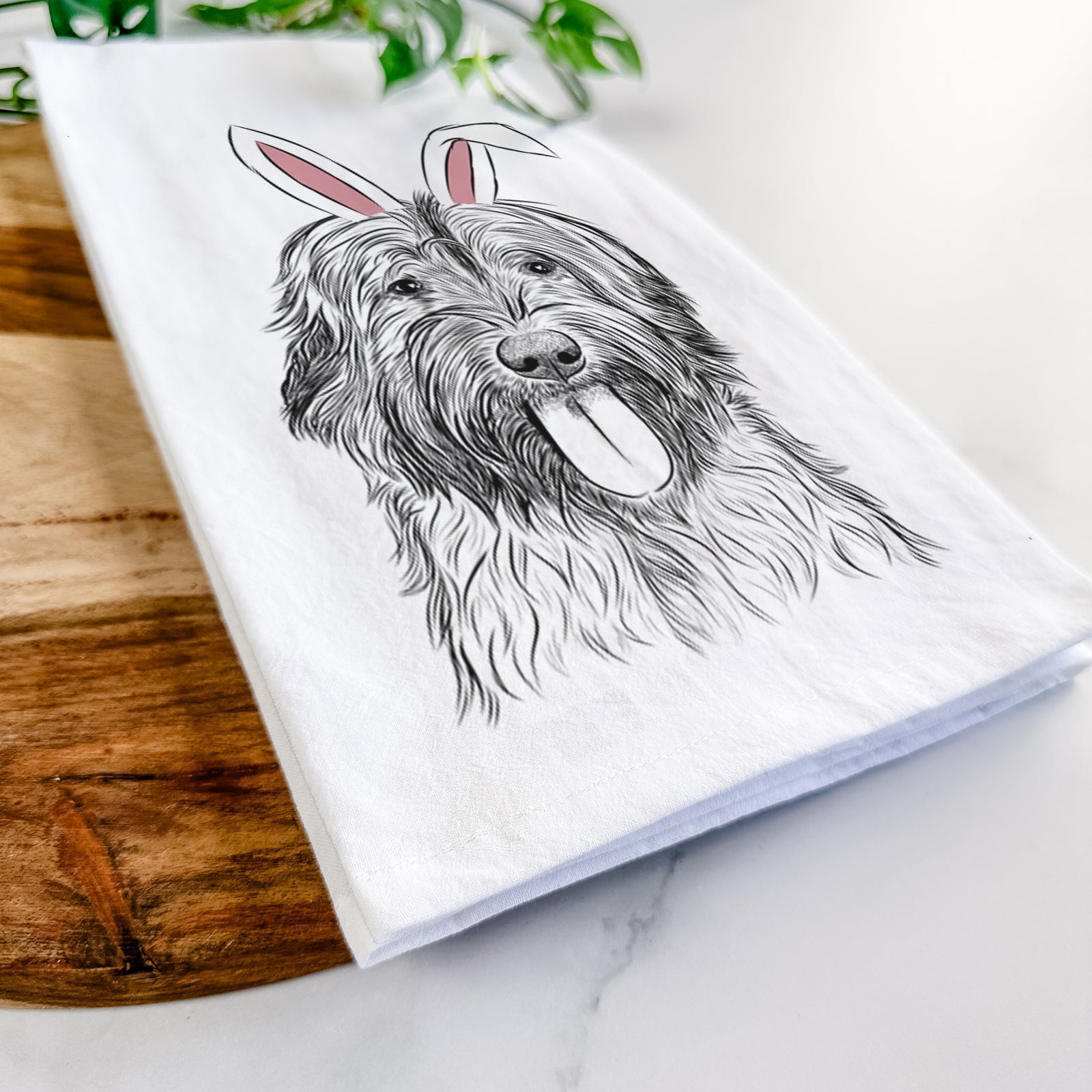 Hand-drawn sketch of Puig the Catalan Sheepdog wearing Easter bunny ears on a tea towel