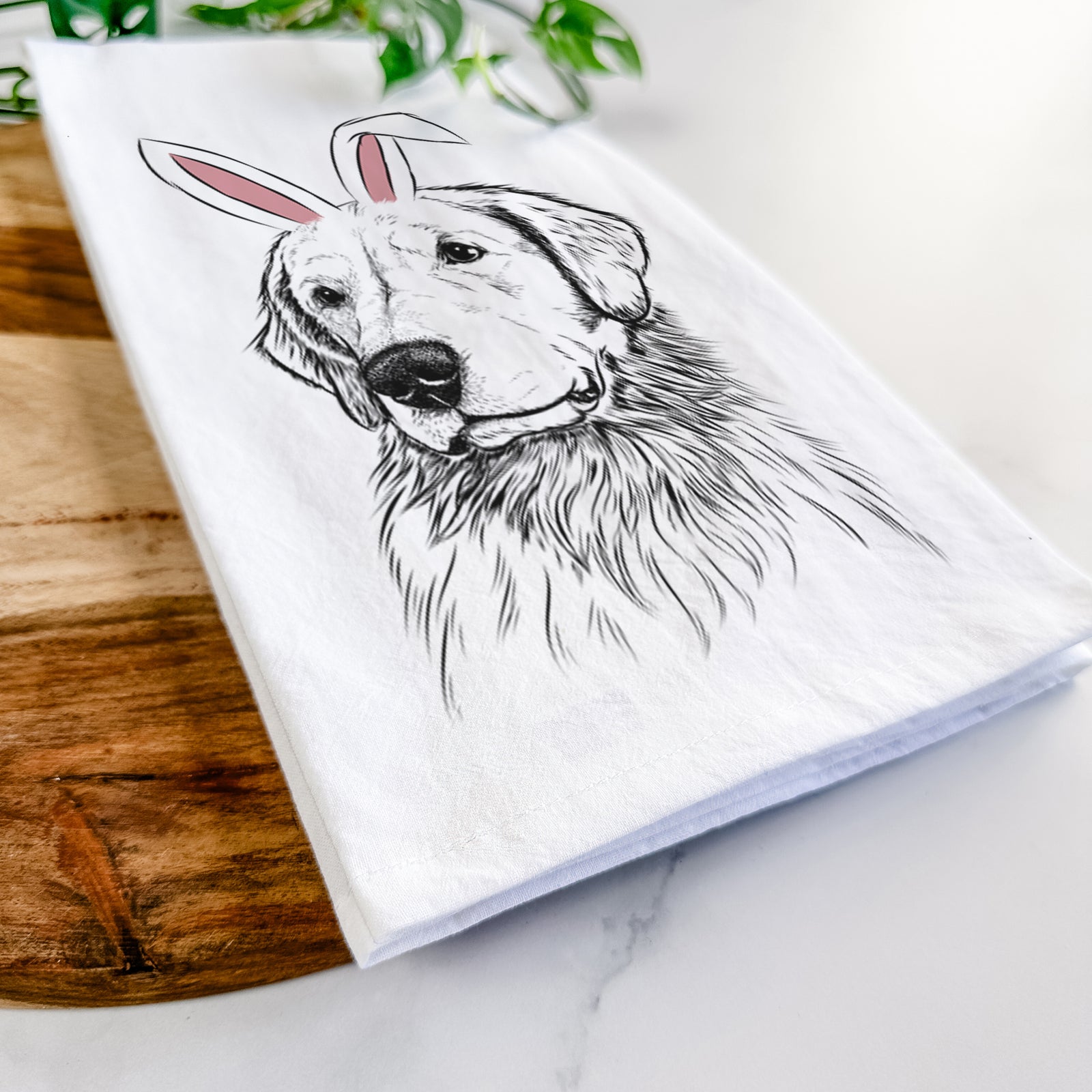 Hand-drawn sketch of Quinn the Golden Retriever wearing Easter bunny ears on a tea towel