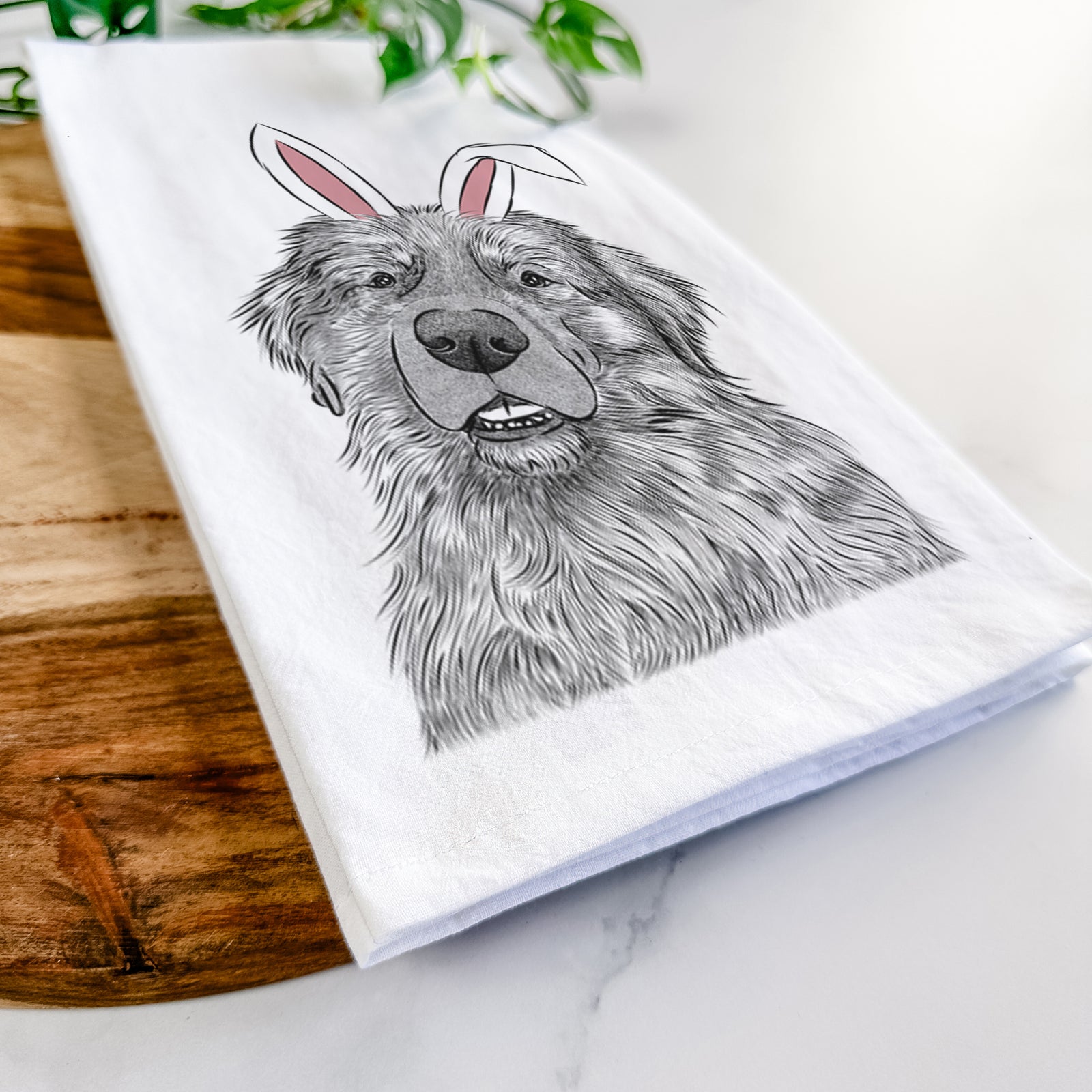 Hand-drawn sketch of Ralph the Leonberger wearing Easter bunny ears on a tea towel