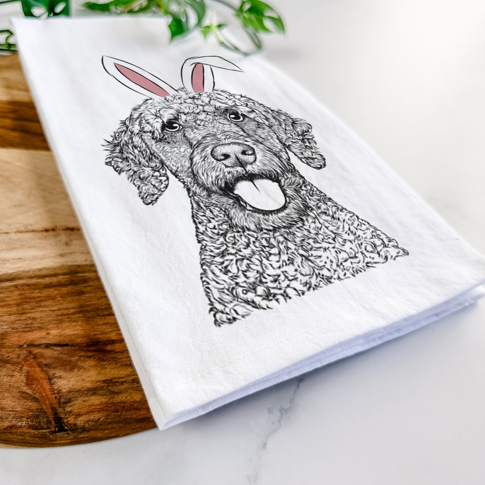 Hand-drawn sketch of Reina the Spanish Water Dog wearing Easter bunny ears on a tea towel