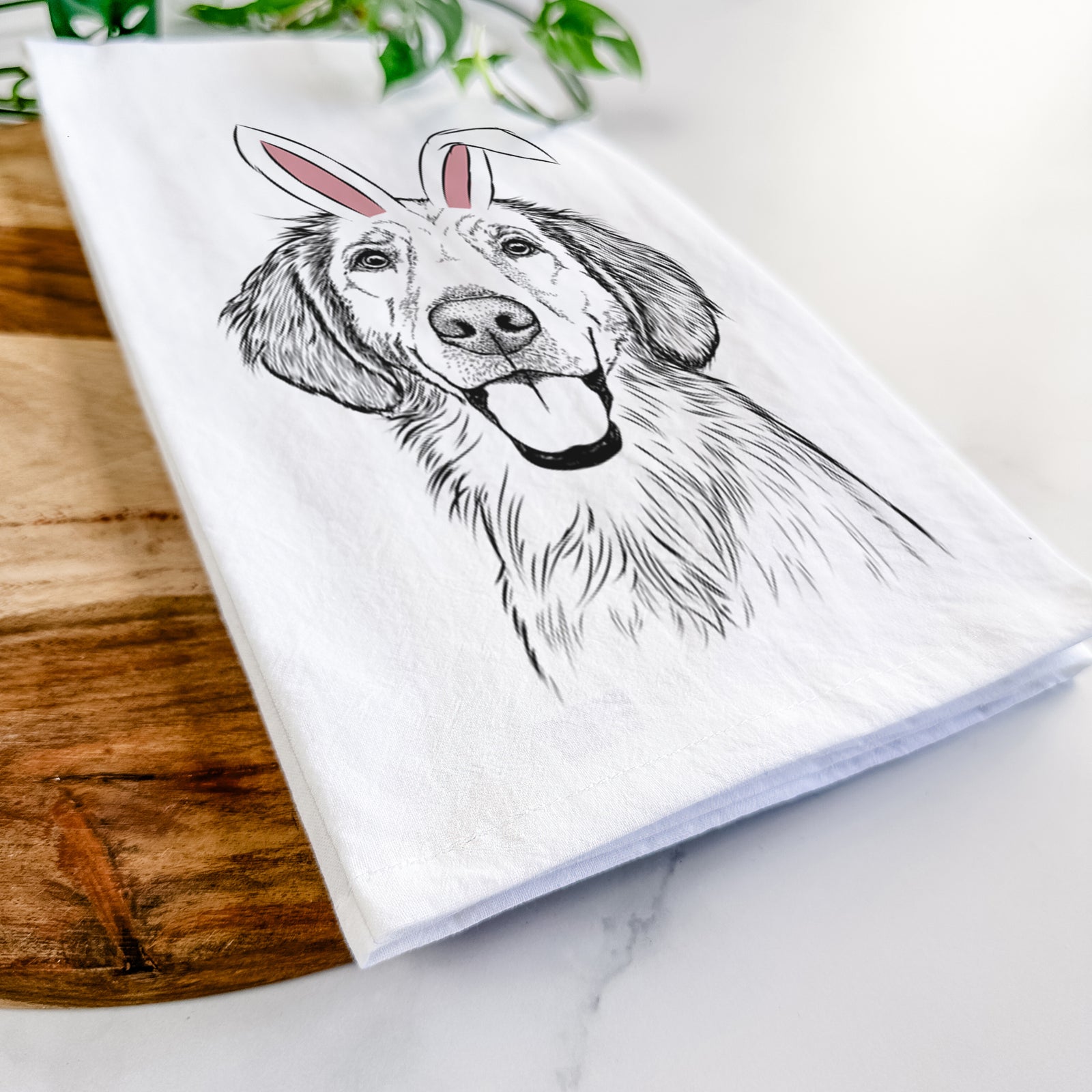 Hand-drawn sketch of Riley the Golden Retriever wearing Easter bunny ears on a tea towel