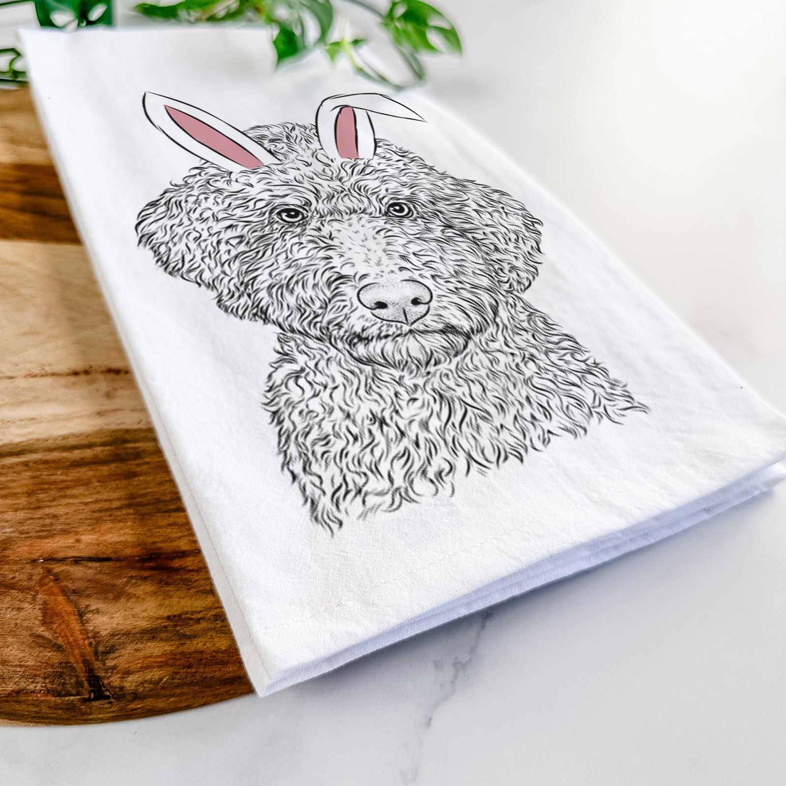Hand-drawn sketch of Ross the Lagotto Romagnolo wearing Easter bunny ears on a tea towel