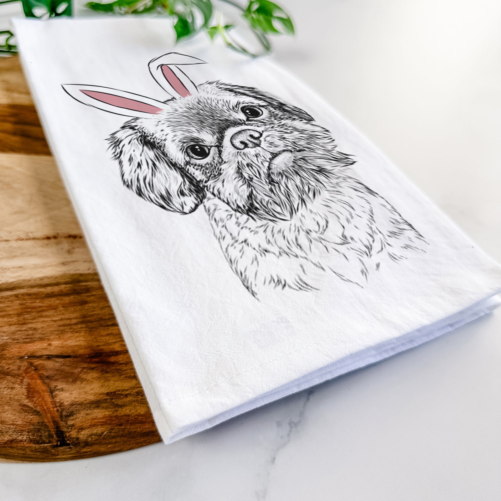 Hand-drawn sketch of Rufus the Shiffon wearing Easter bunny ears on a tea towel