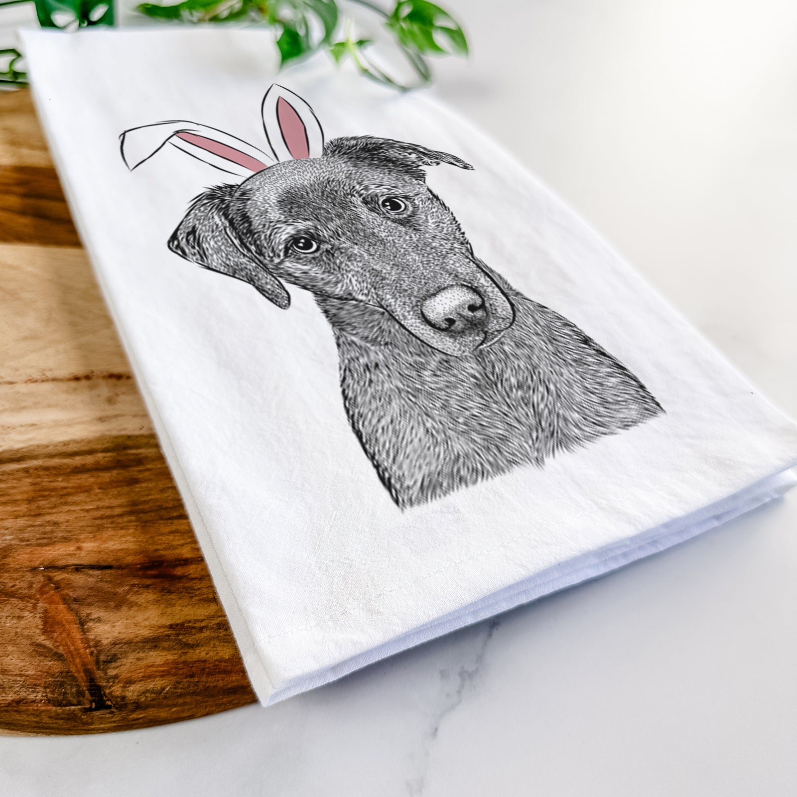 Hand-drawn sketch of Sadie the Whipador wearing Easter bunny ears on a tea towel