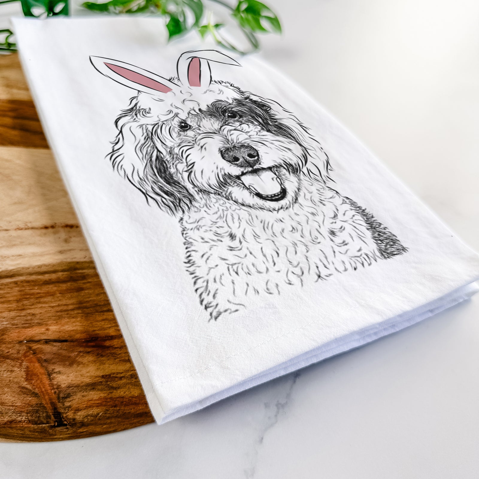 Hand-drawn sketch of Sherlock the Sheepadoodle wearing Easter bunny ears on a tea towel