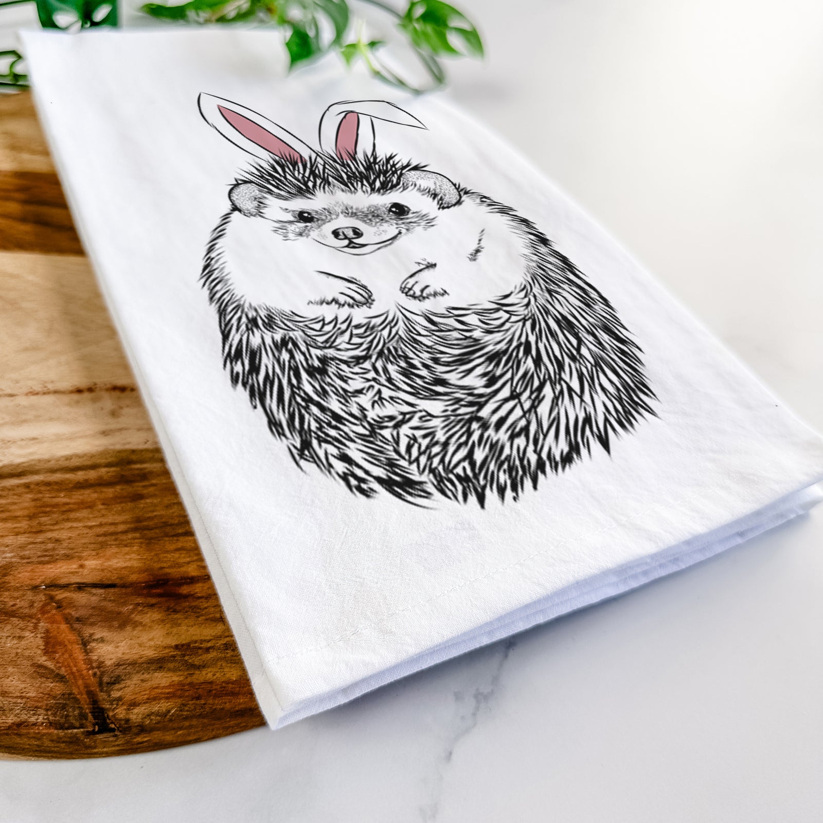 Hand-drawn sketch of Sid the Hedgehog wearing Easter bunny ears on a tea towel