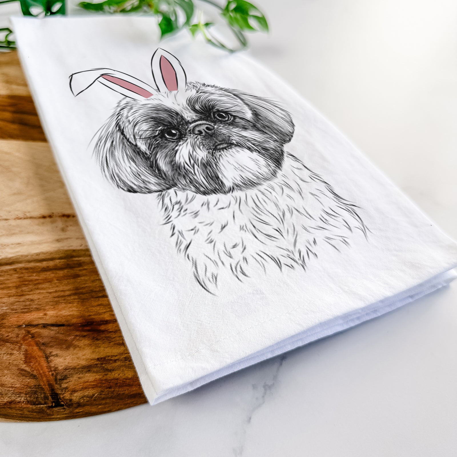 Hand-drawn sketch of Simon the Shih Tzu wearing Easter bunny ears on a tea towel