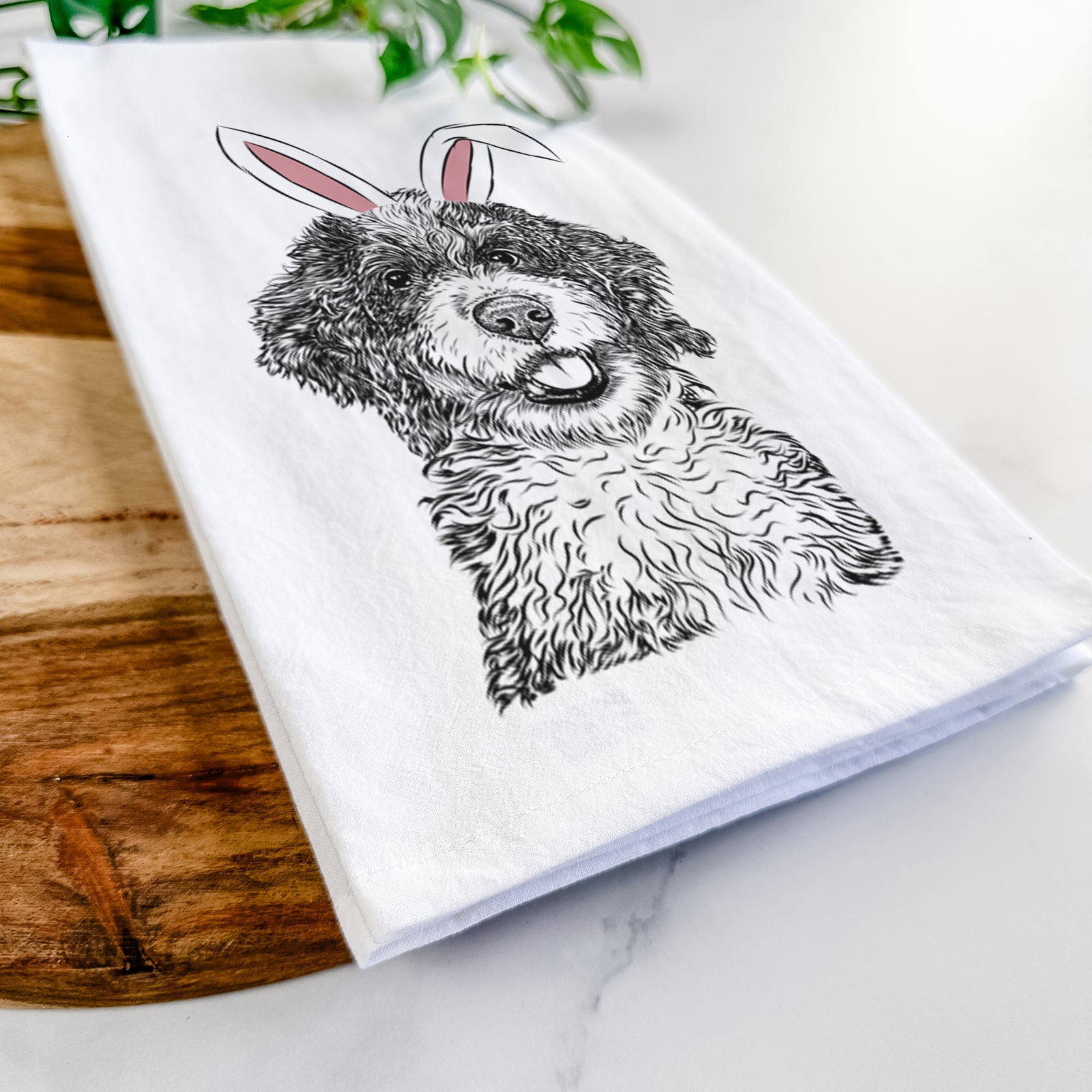 Hand-drawn sketch of Smoky the Bernedoodle Puppy wearing Easter bunny ears on a tea towel