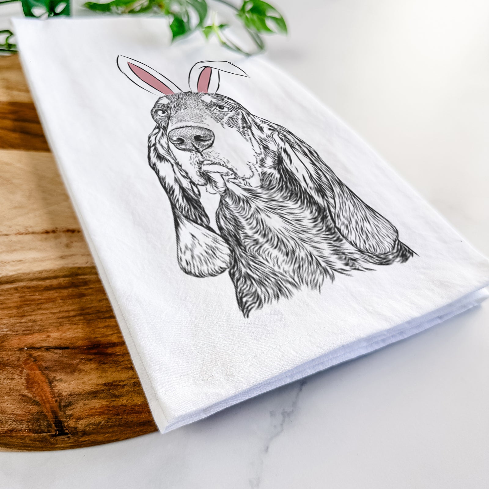 Hand-drawn sketch of Stu the Black and Tan Coonhound wearing Easter bunny ears on a tea towel