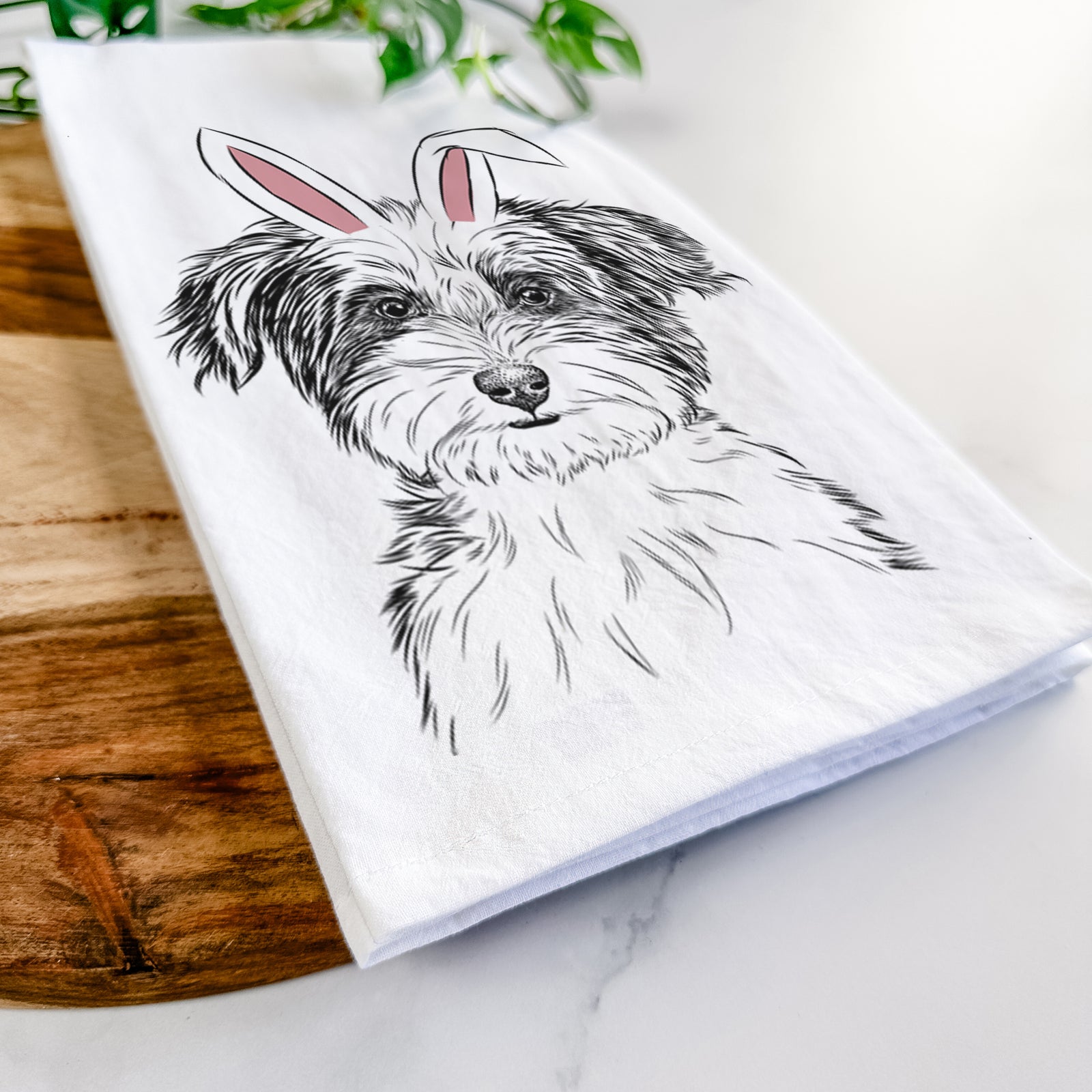 Hand-drawn sketch of Teddy the Havanese wearing Easter bunny ears on a tea towel