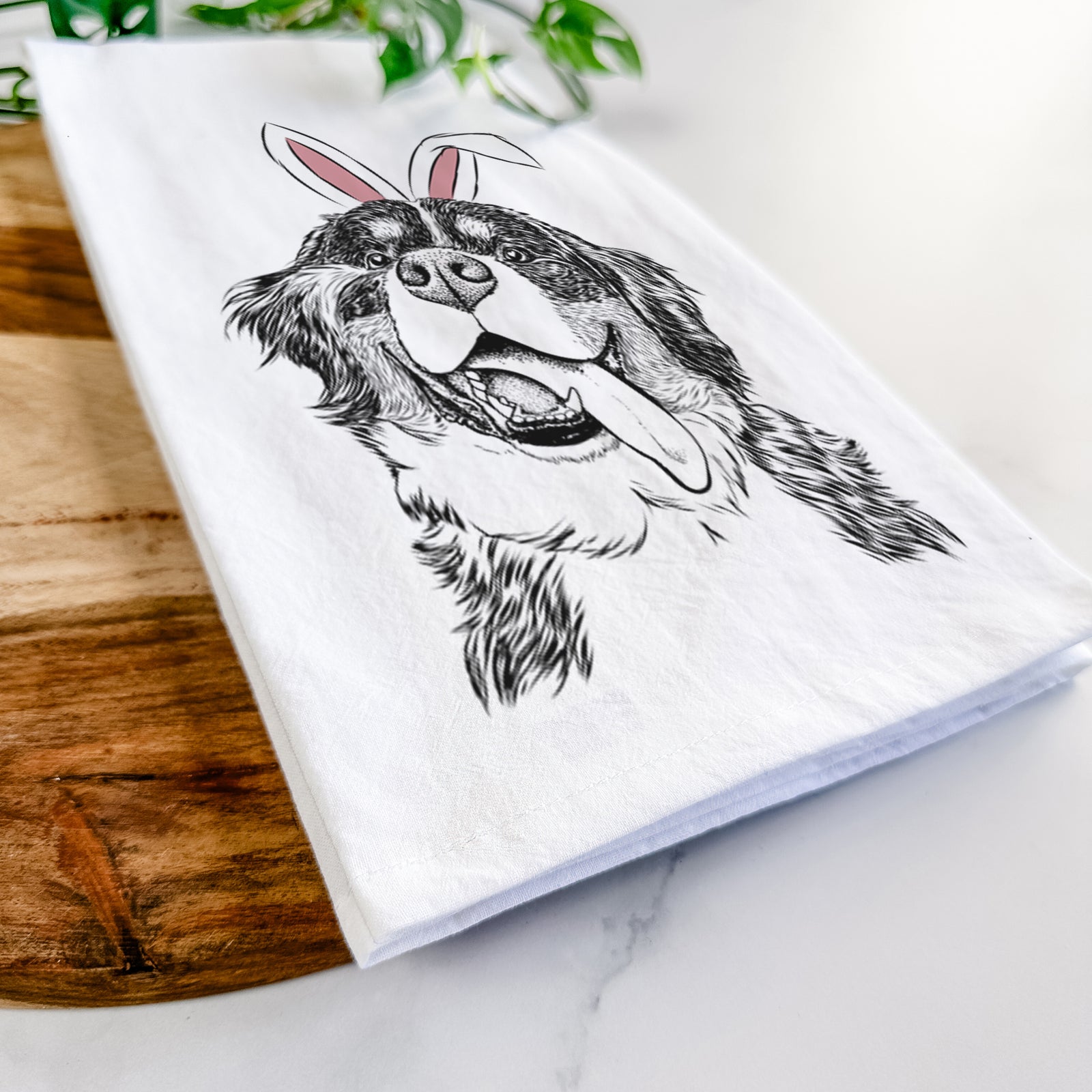Hand-drawn sketch of Theo the Bernese Mountain Dog wearing Easter bunny ears on a tea towel