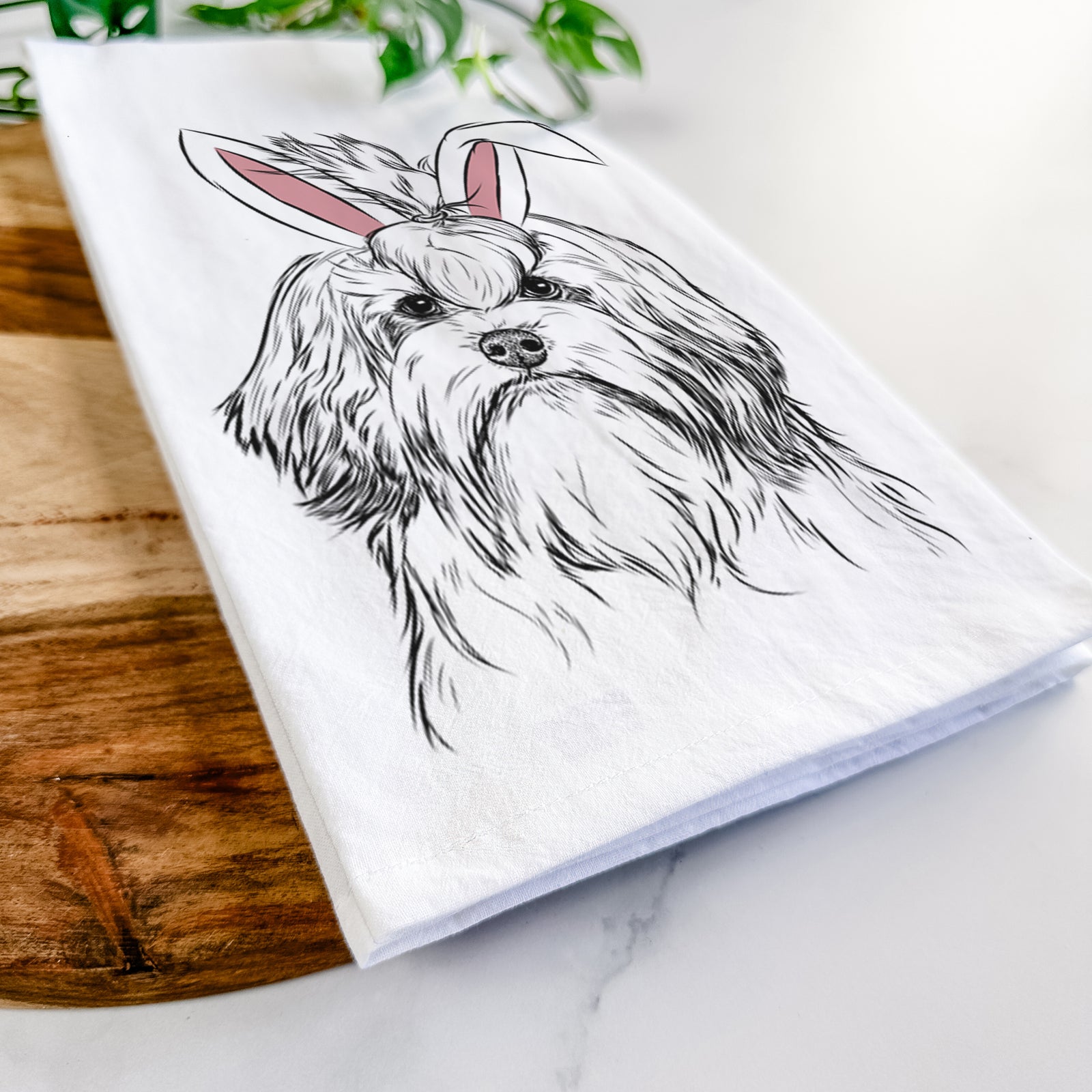 Hand-drawn sketch of Tootsie the Lowchen wearing Easter bunny ears on a tea towel