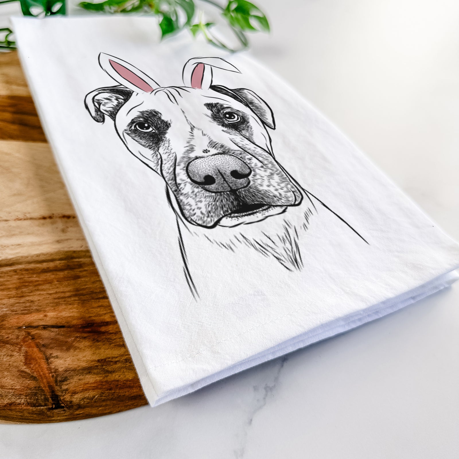 Hand-drawn sketch of Waylon the Boxane wearing Easter bunny ears on a tea towel