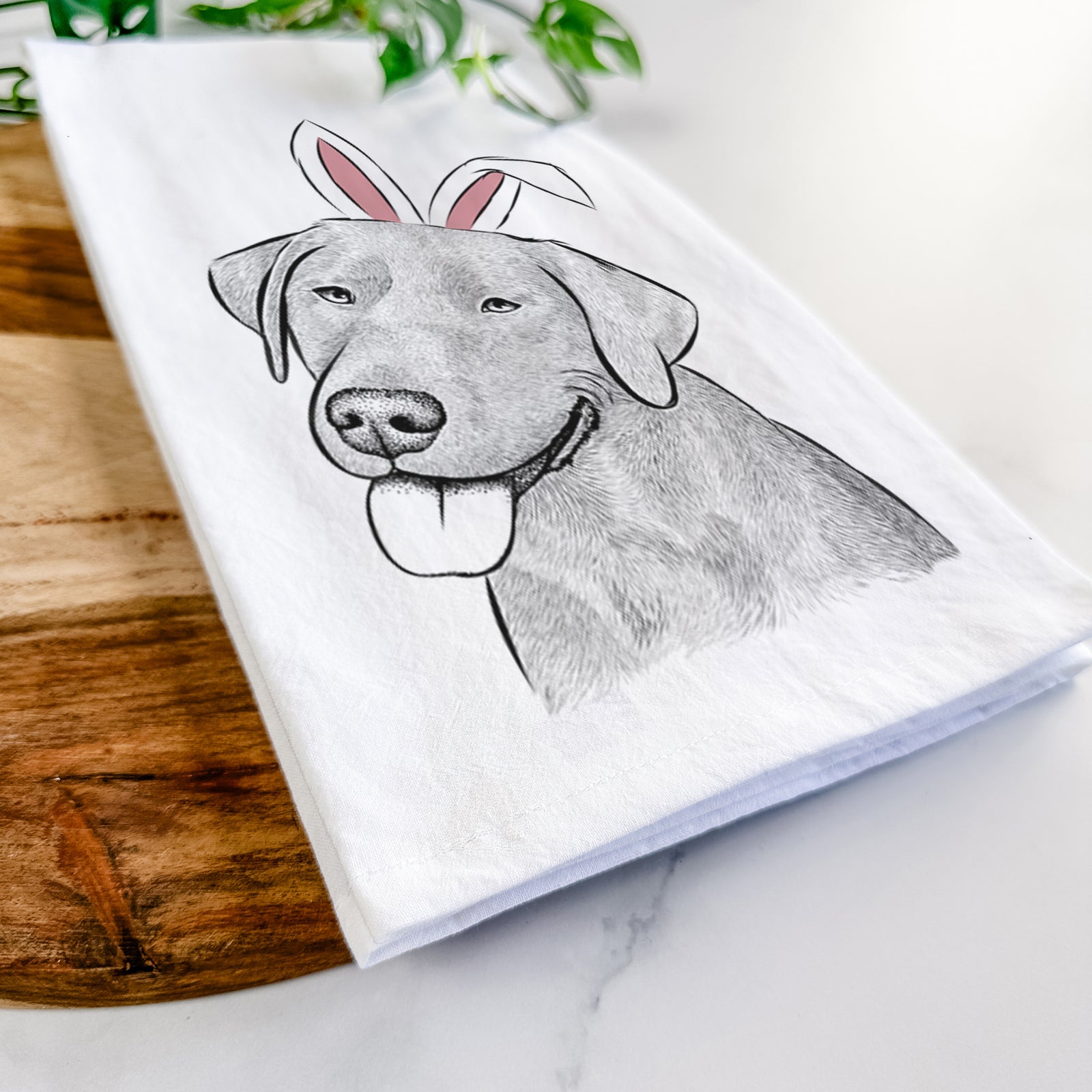 Hand-drawn sketch of Zeppelin the Black Labrador wearing Easter bunny ears on a tea towel