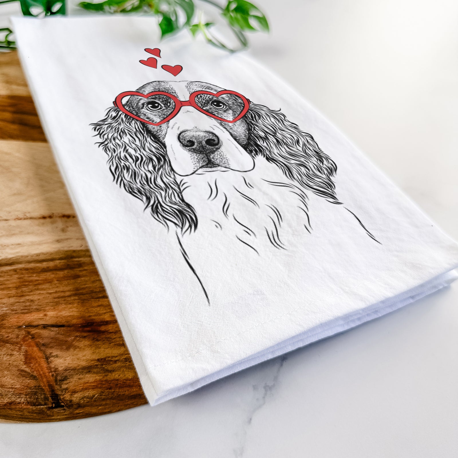 Hand-drawn sketch of Annie the English Springer Spaniel wearing heart-shaped glasses on a tea towel