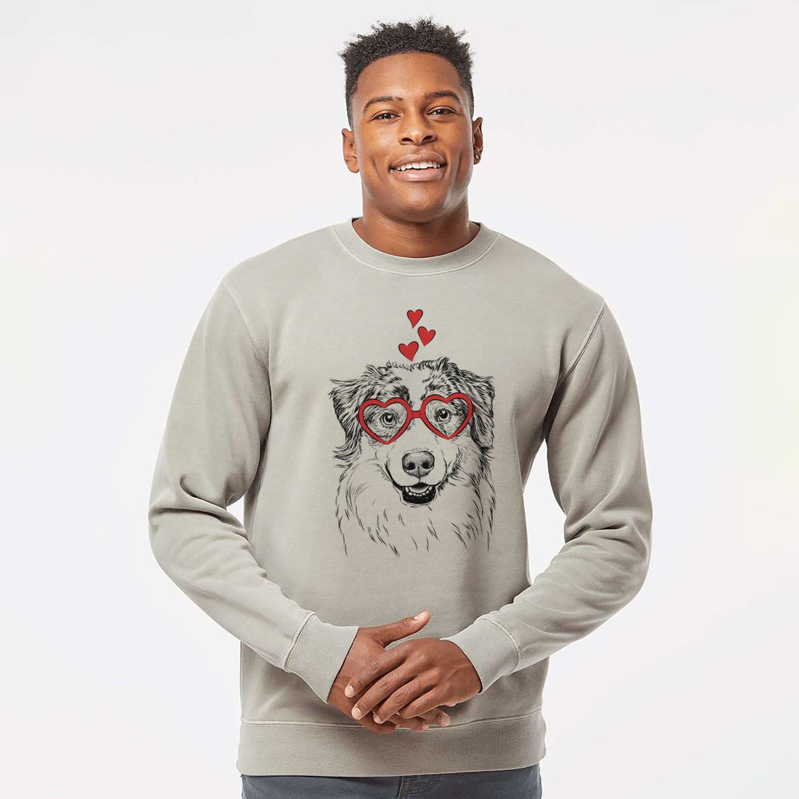Hand-drawn sketch of Aonghus the Australian Shepherd wearing heart-shaped glasses on a Cement Unisex pigment dyed crew sweatshirt