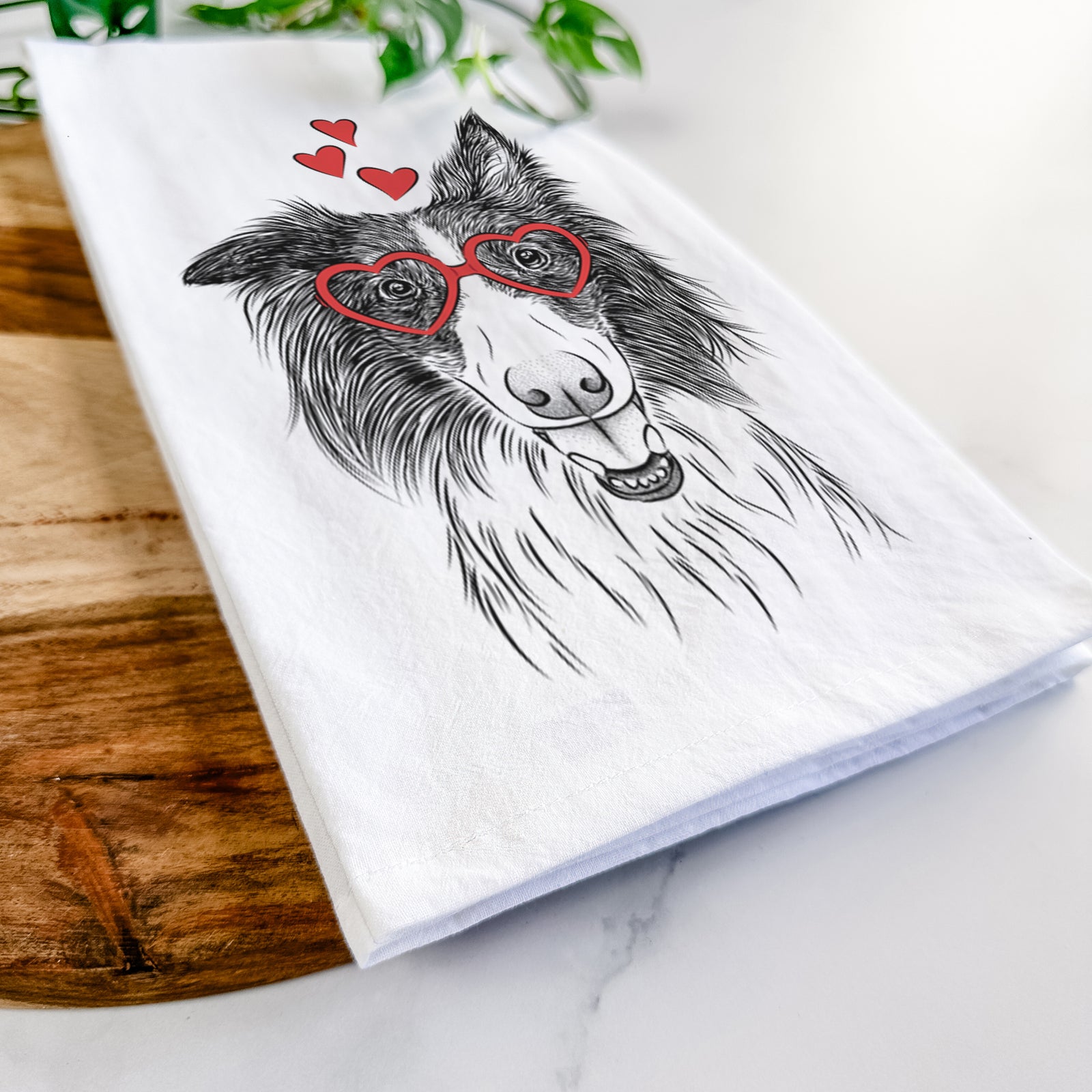 Hand-drawn sketch of Archie the Silken Windhound wearing heart-shaped glasses on a tea towel