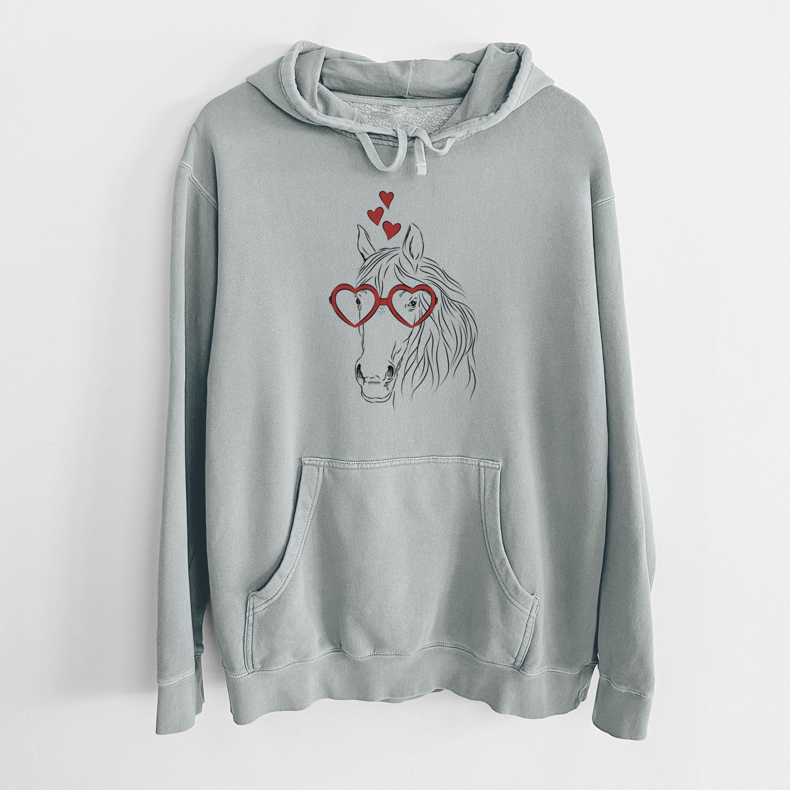 Hand-drawn sketch of Aria the Horse wearing heart-shaped glasses on a Sage Unisex pigment dyed hoodie