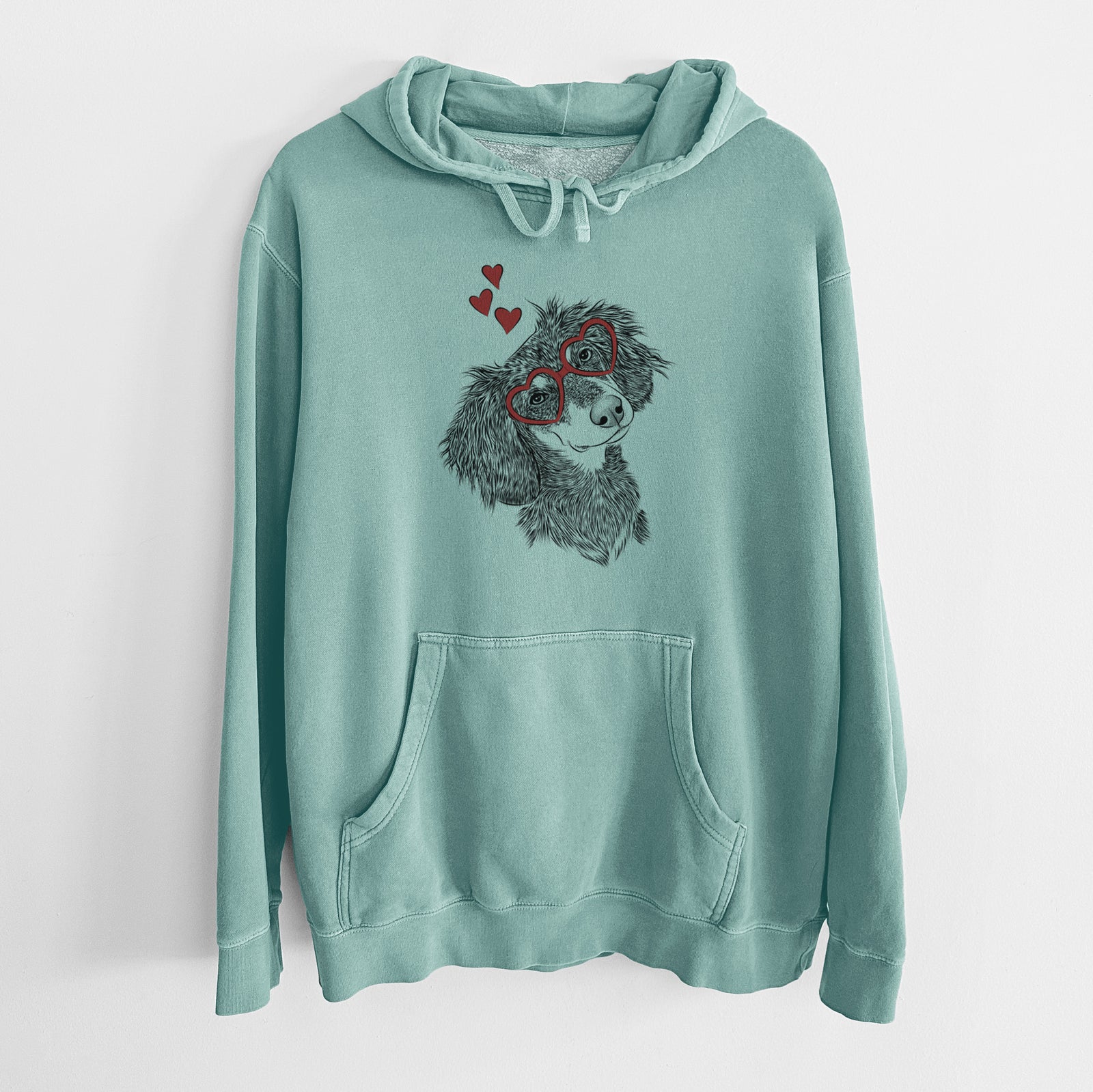 Hand-drawn sketch of Bailey the Long Haired Dachshund wearing heart-shaped glasses on a Mint Unisex pigment dyed hoodie