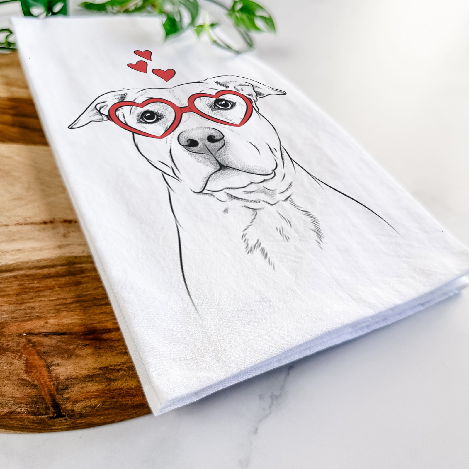 Hand-drawn sketch of Bailey the American Staffordshire Terrier wearing heart-shaped glasses on a tea towel