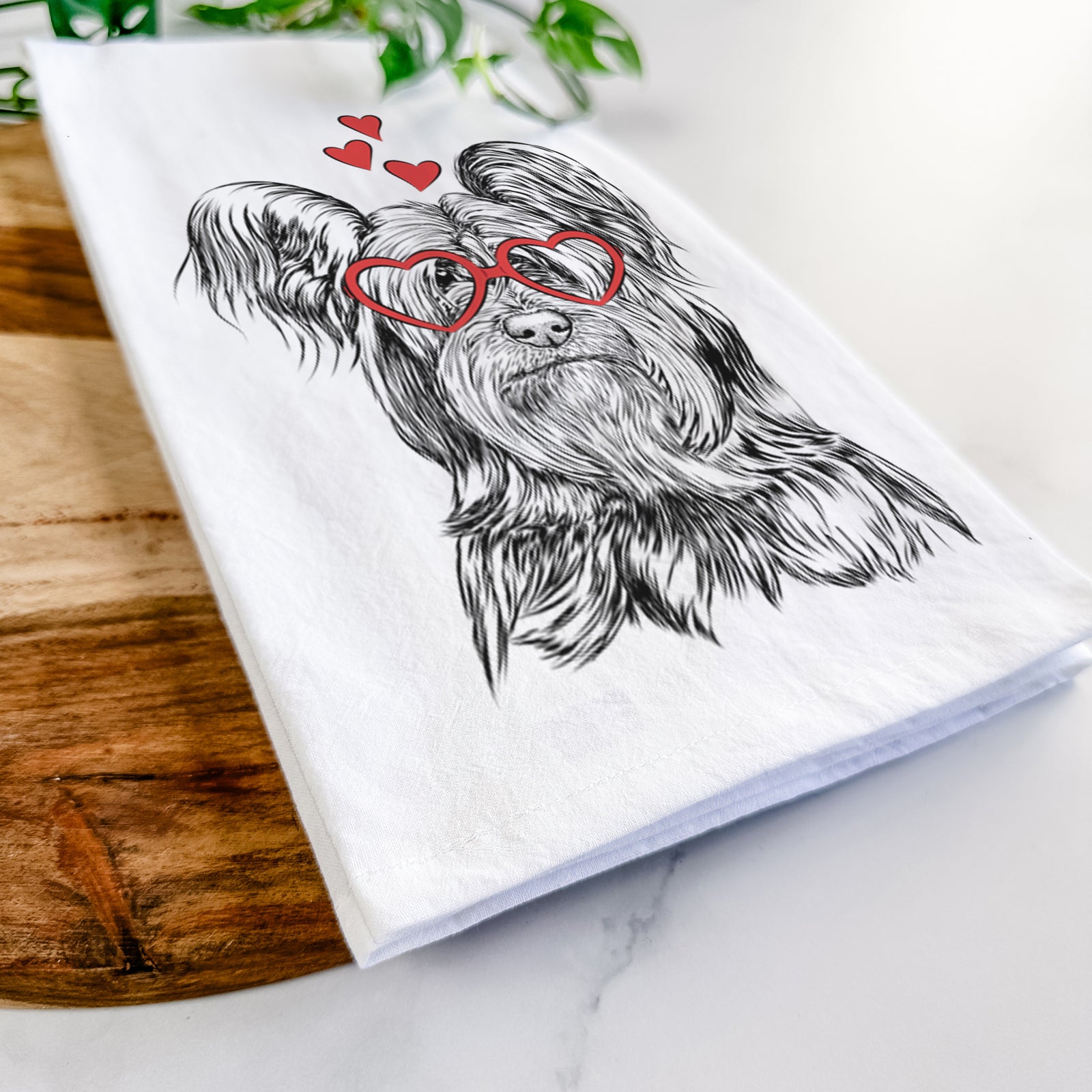 Hand-drawn sketch of Bandit the Skye Terrier wearing heart-shaped glasses on a tea towel