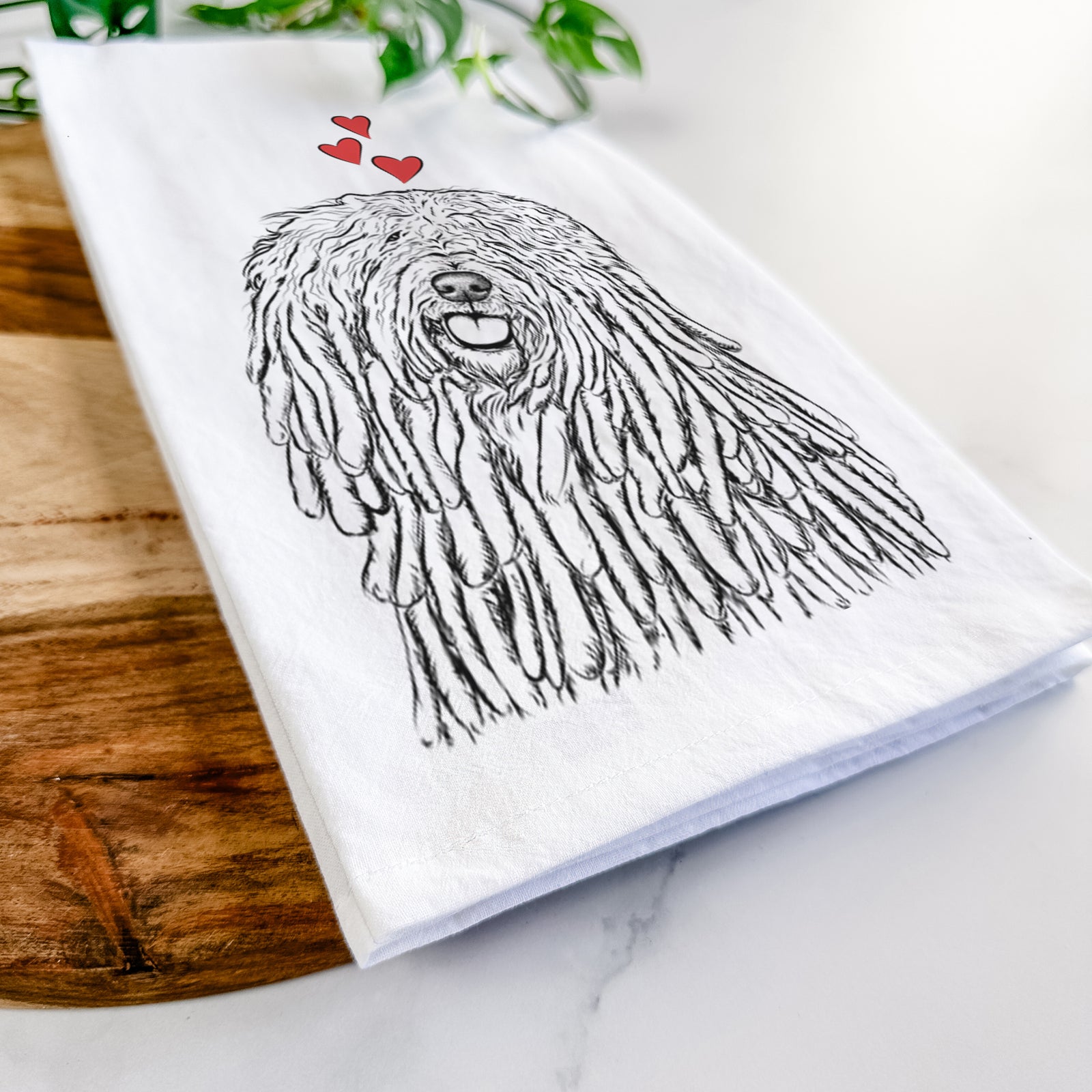 Hand-drawn sketch of Barry the Komondor wearing heart-shaped glasses on a tea towel