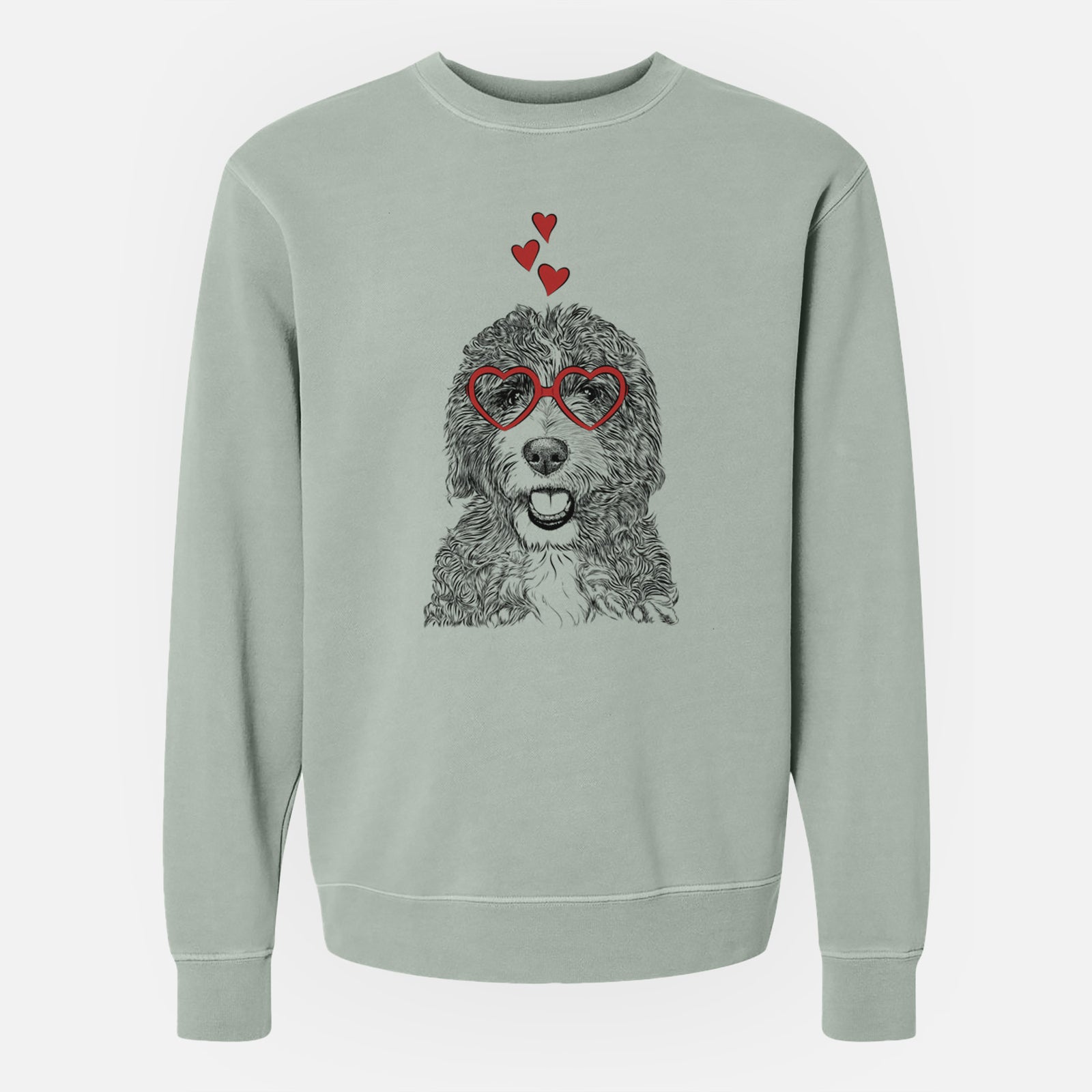 Hand-drawn sketch of Bash the Bernedoodle wearing heart-shaped glasses on a Sage Unisex pigment dyed crew sweatshirt