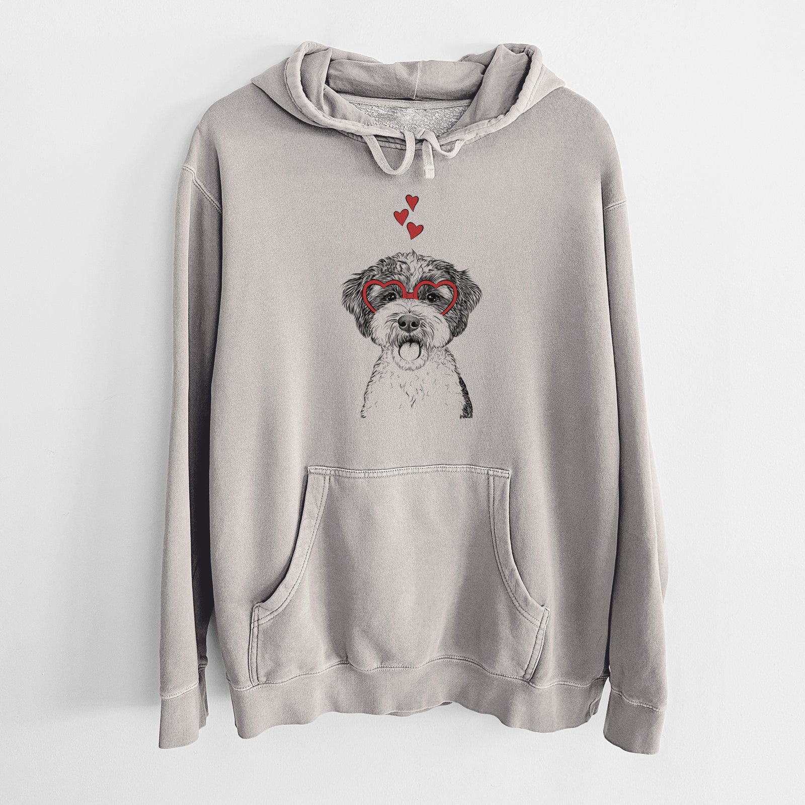 Hand-drawn sketch of Bella the Cockapoo wearing heart-shaped glasses on a Cement Unisex pigment dyed hoodie