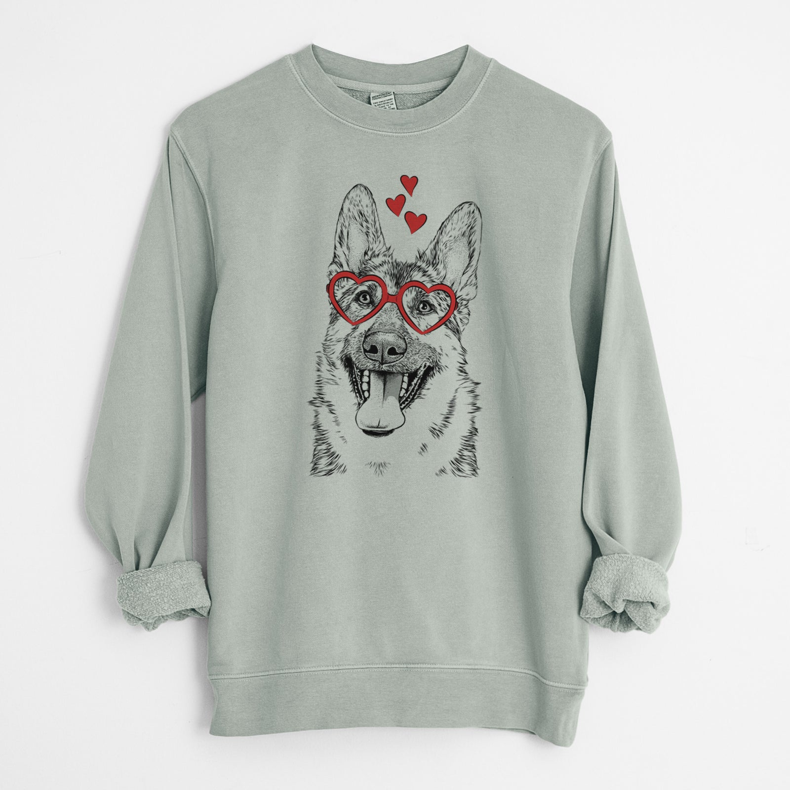 Hand-drawn sketch of Benson the German Shepherd wearing heart-shaped glasses on a Sage Unisex pigment dyed crew sweatshirt