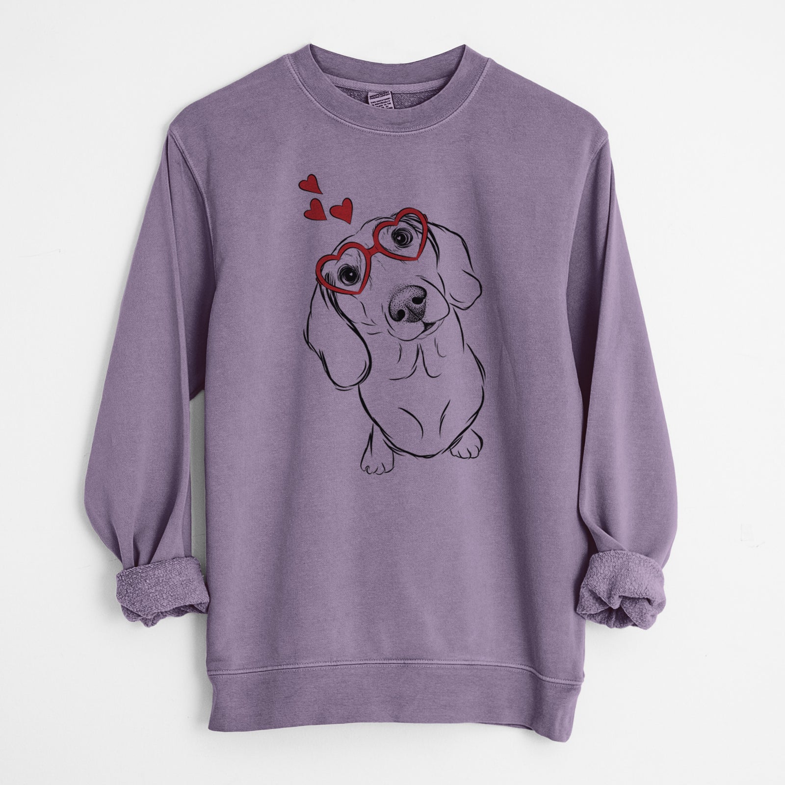 Hand-drawn sketch of Bill the Dachshund wearing heart-shaped glasses on a Plum Unisex pigment dyed crew sweatshirt
